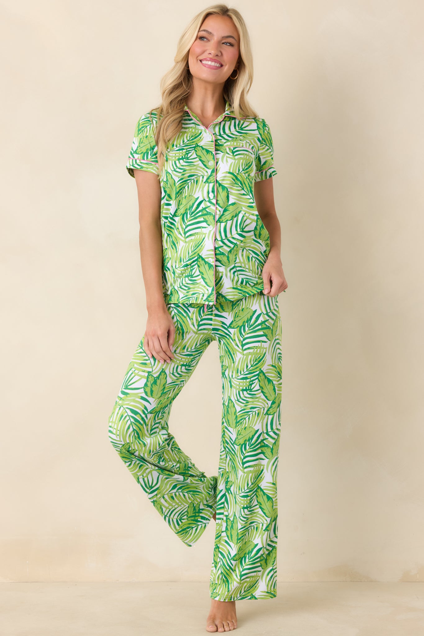 Green palm and leaf print button-front top with short sleeves, notched collar, and relaxed fit