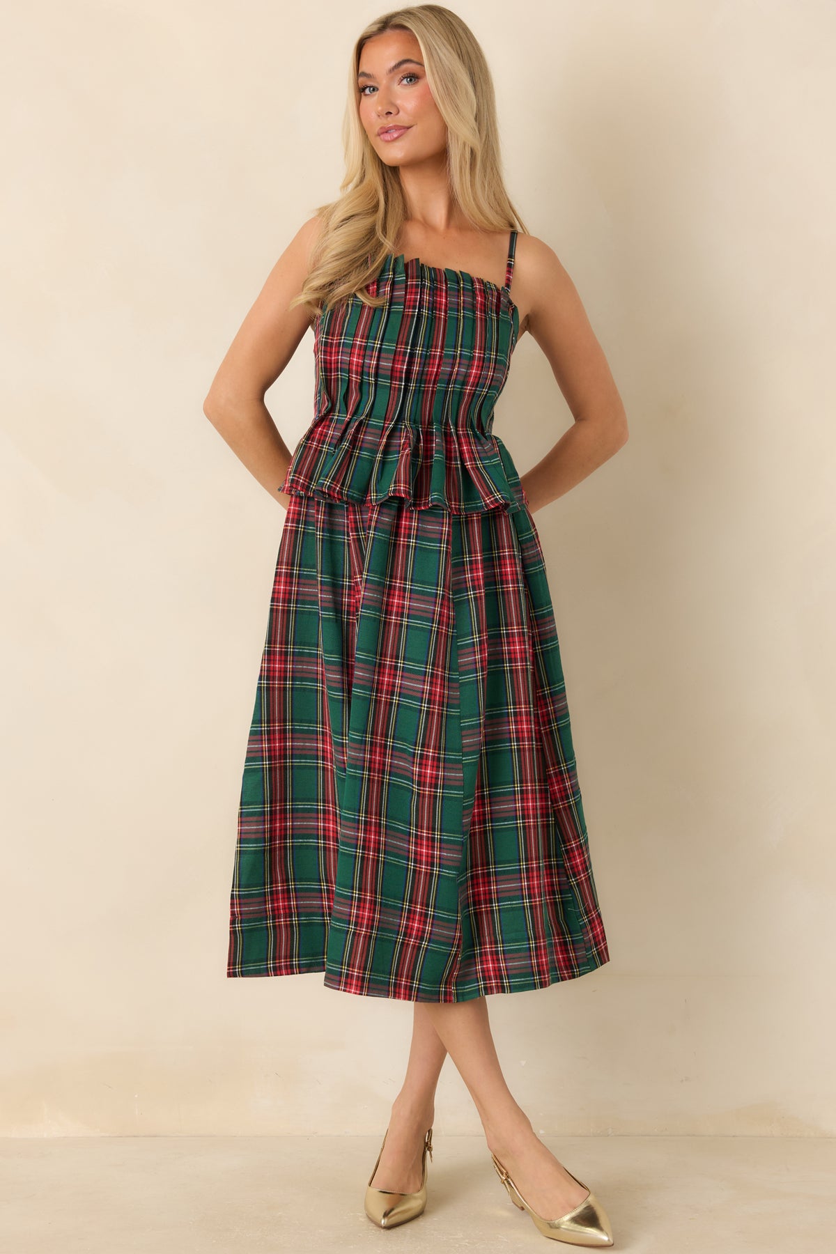 Classic green plaid dress with thin adjustable straps, a shaped bodice, and a flowing midi skirt.