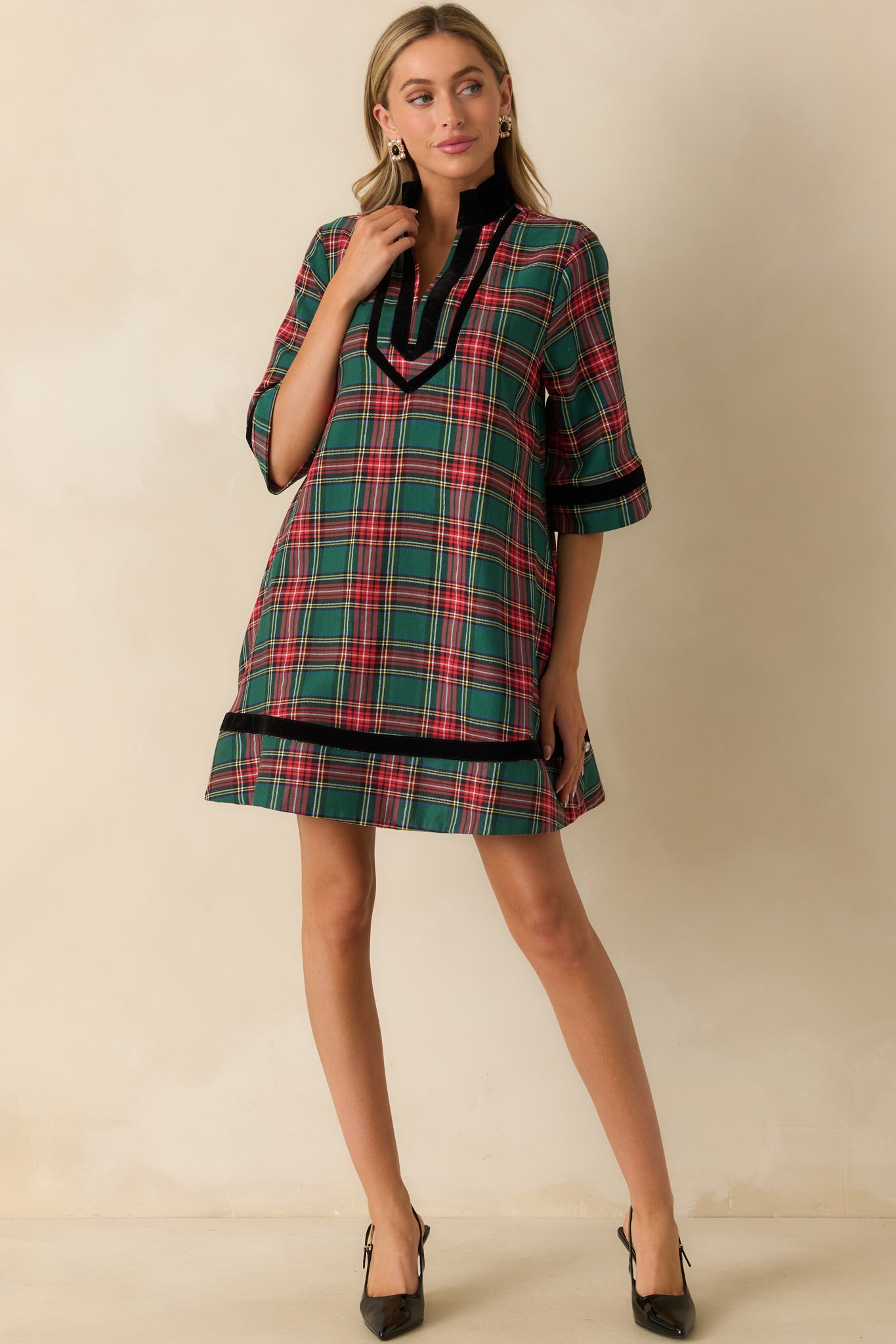 Relaxed-fit green plaid mini dress with full lining, soft woven texture, and black velvet trim accents.