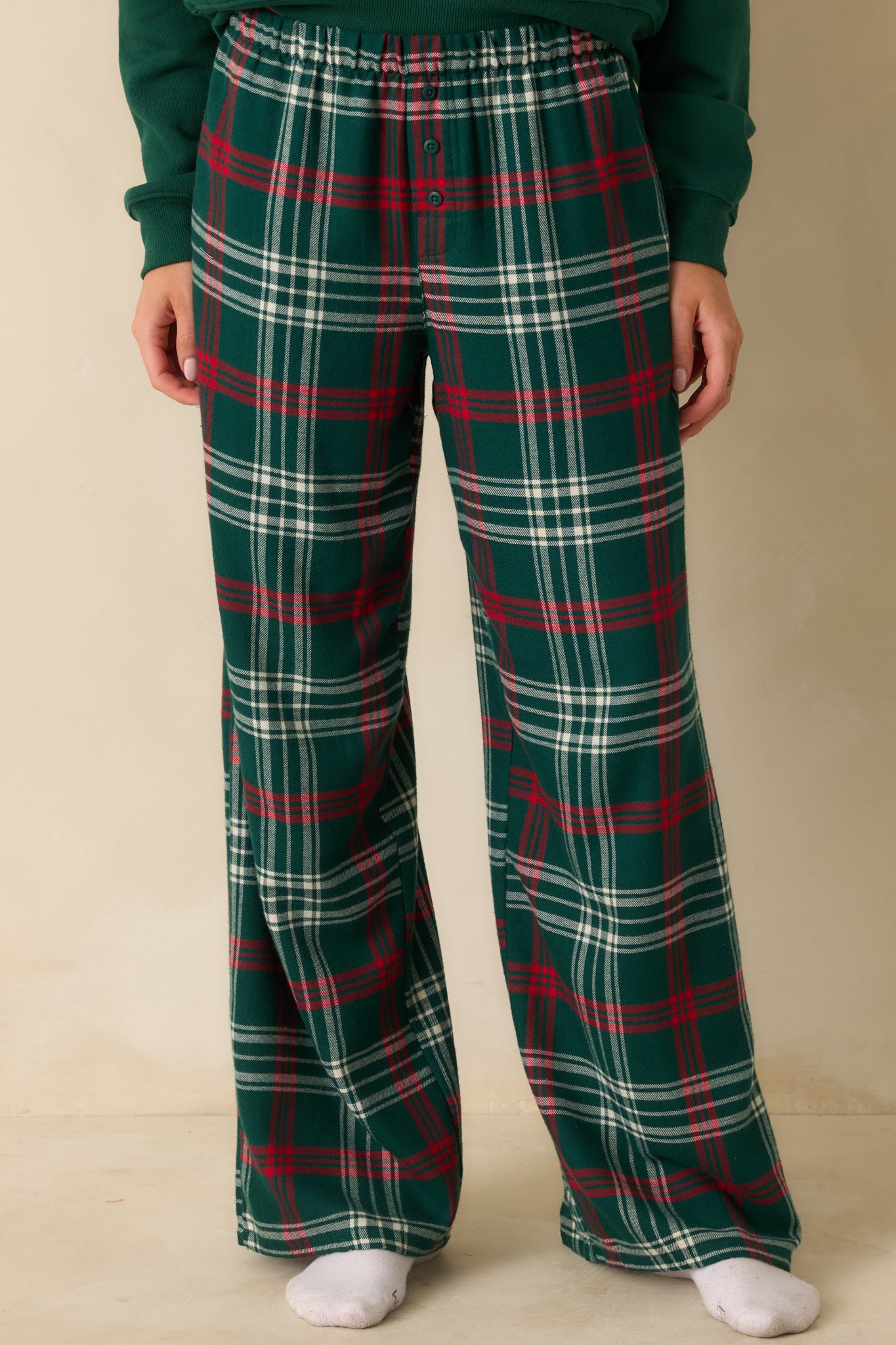 Green plaid straight-leg pajama pants in lightweight flannel with high-rise elastic waistband and relaxed fit.