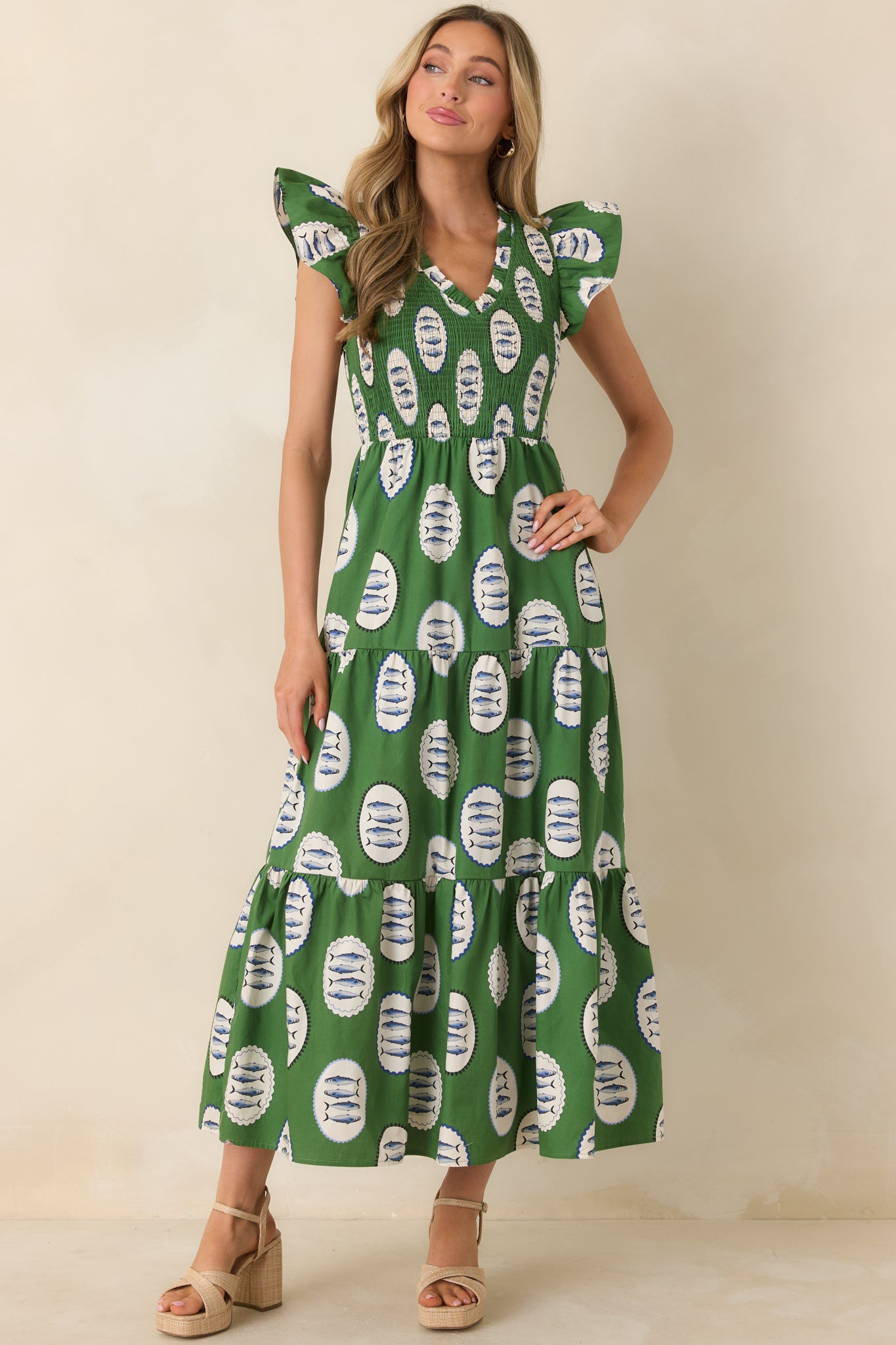 Rich green printed maxi dress with V-neckline, tiered silhouette, and soft, flowing skirt