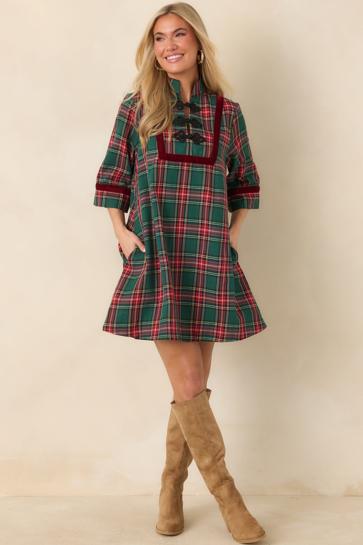 Green and red plaid mini dress with burgundy velvet trim, a stand collar, and black braided frog closures.
