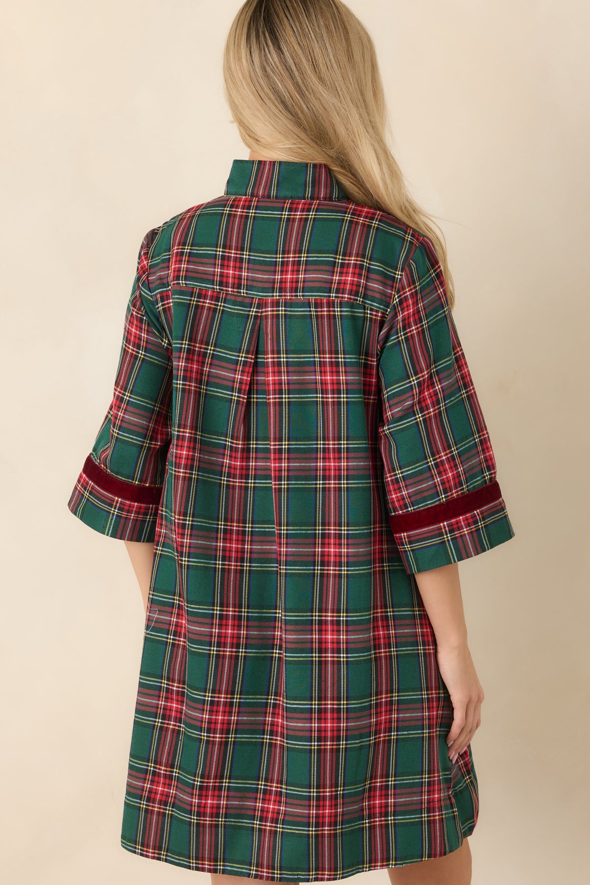 Rear view of the green and red plaid mini dress showing the back pleat and relaxed A-line shape.