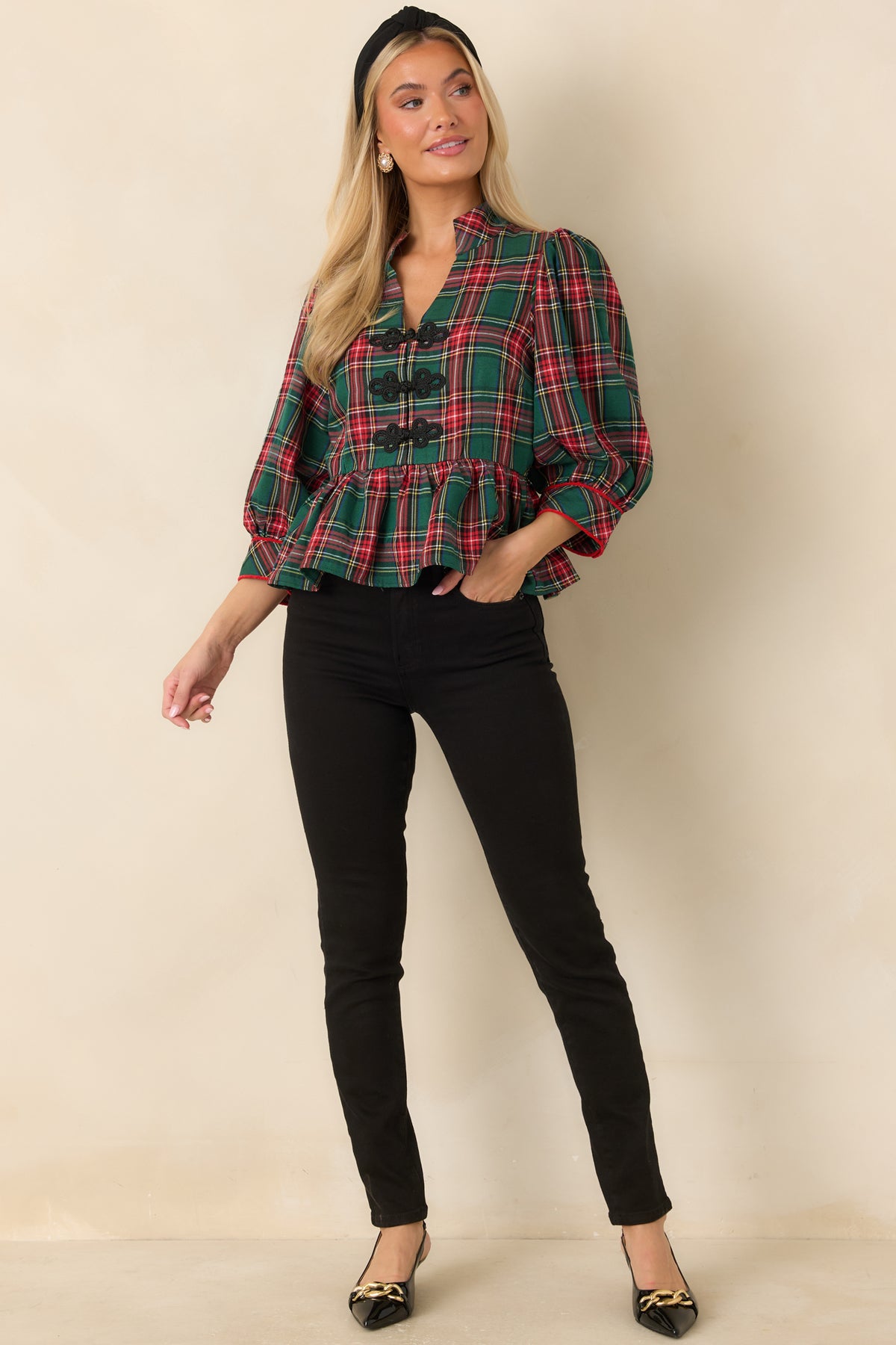 Green and red plaid peplum top with a structured stand collar and buttoned sleeve cuffs.