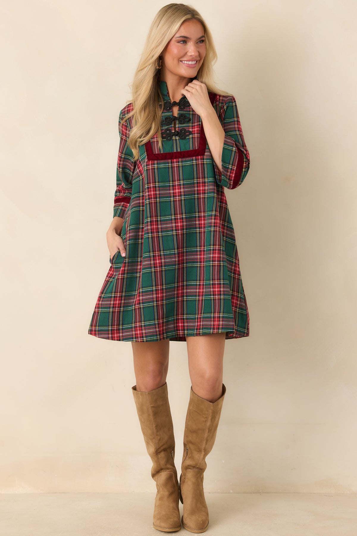 Green and red tartan dress with a velvet-framed front panel and gently flared A-line shape.