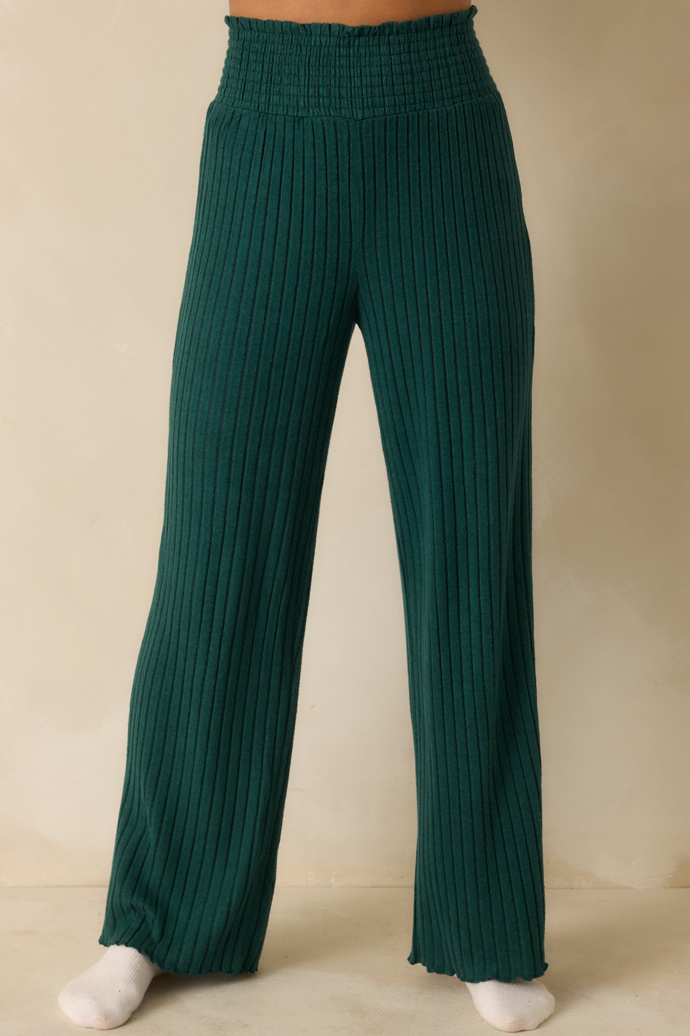 Silky ribbed knit fabric in green, highlighting smocked waistband and midweight stretch for smooth comfort.