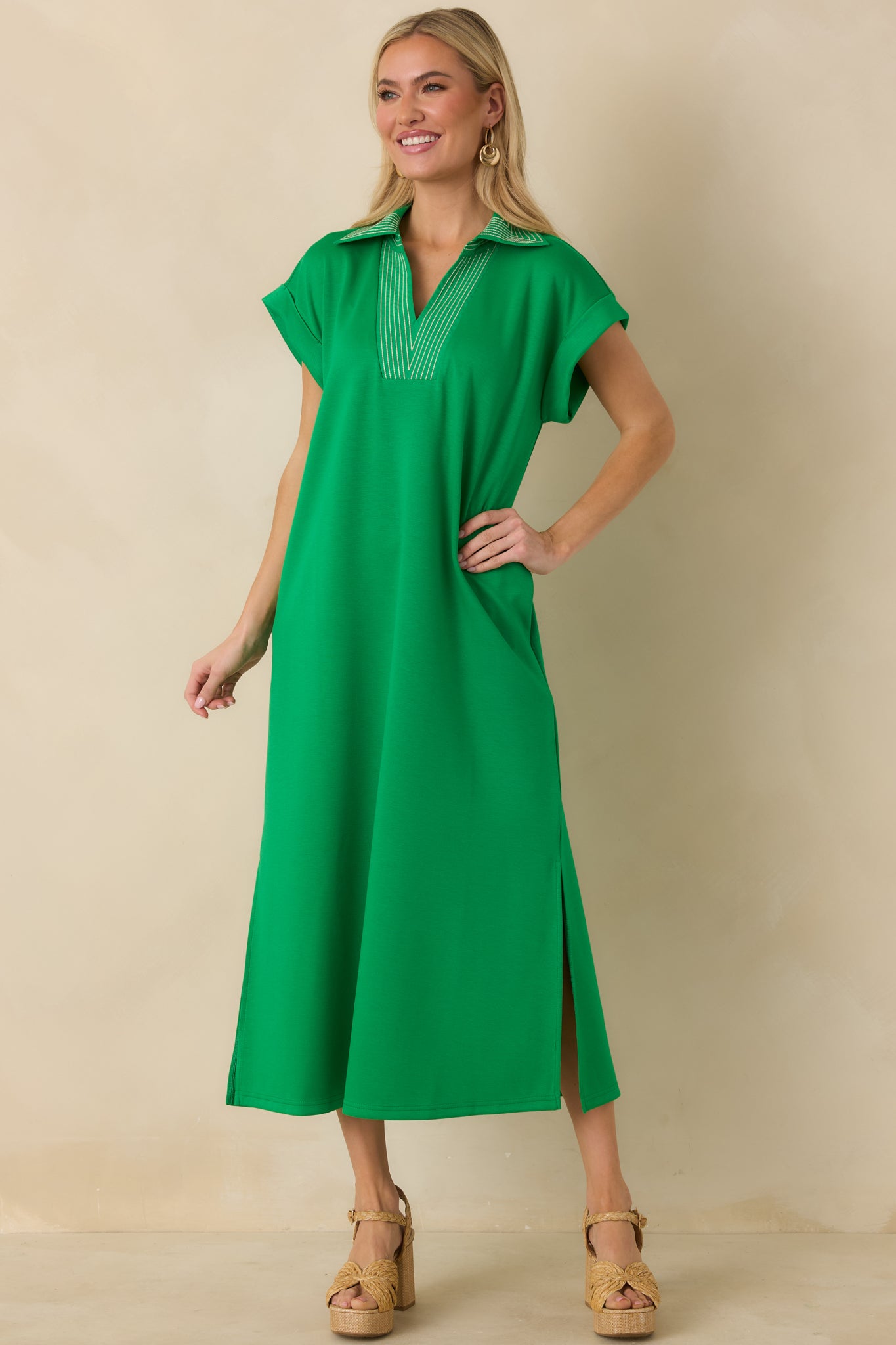 Green short sleeve midi dress with relaxed shape and side slit accents.