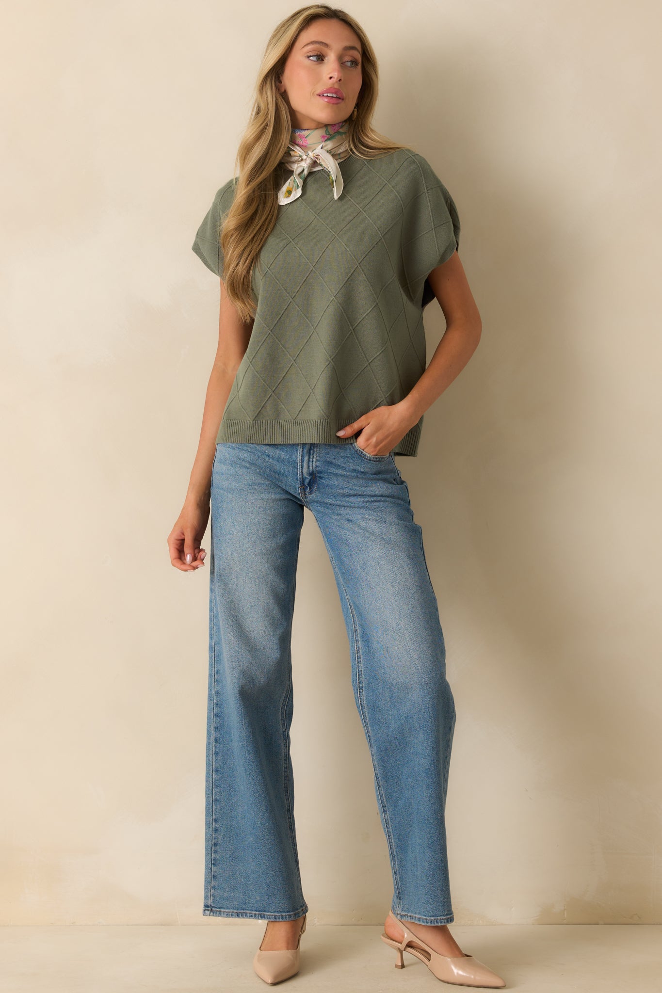 Green short-sleeve sweater showing relaxed fit, rolled crew neckline, and straight hemline.