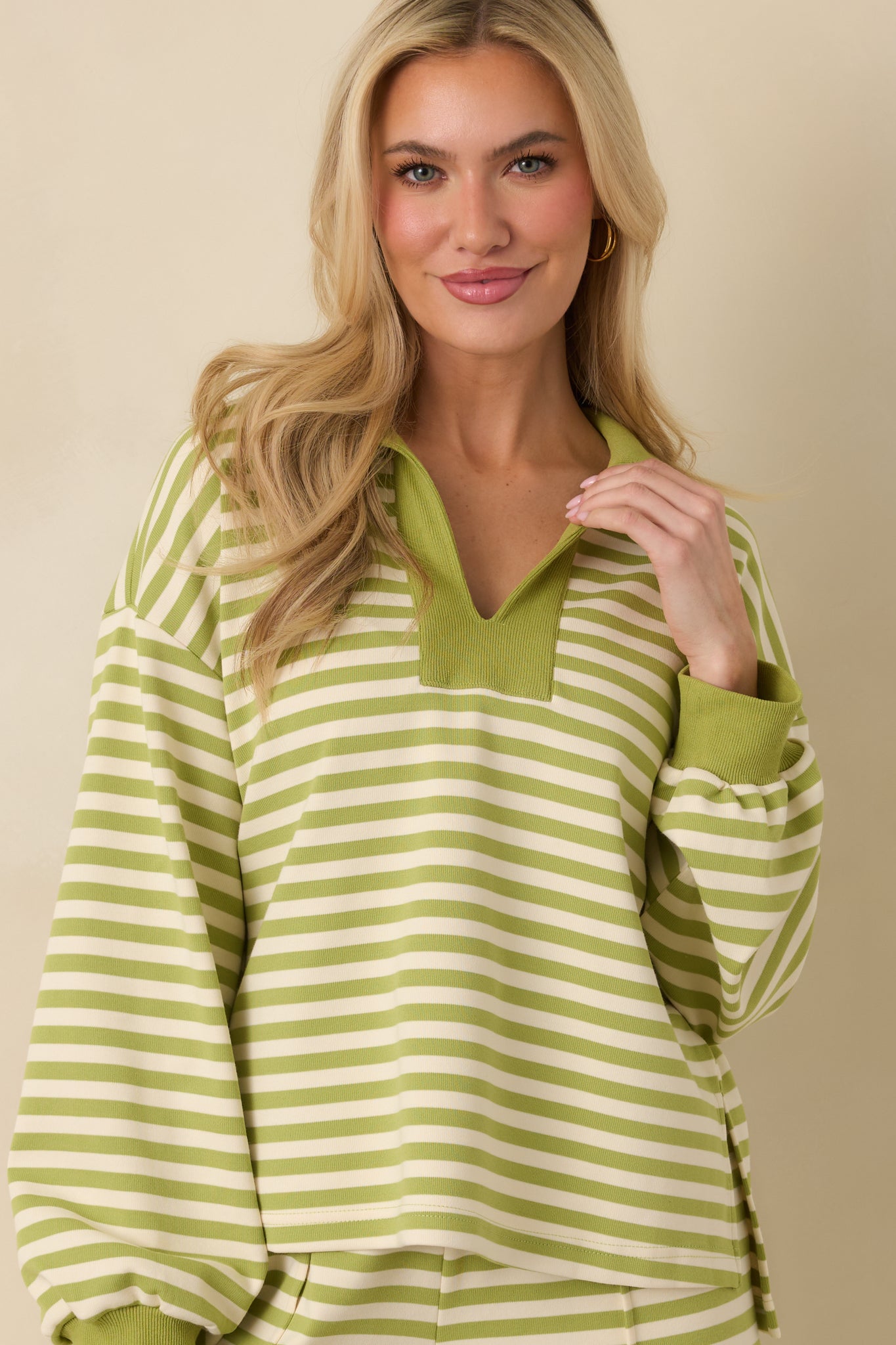 Green striped lounge top focusing on the long sleeves and ribbed cuffs for a comfortable fit.
