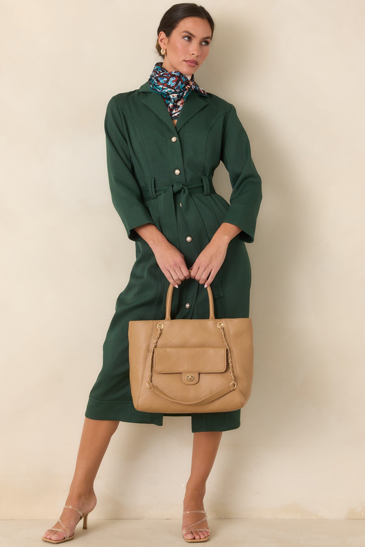  Tailored green midi dress with a cinched waist and straight skirt silhouette.