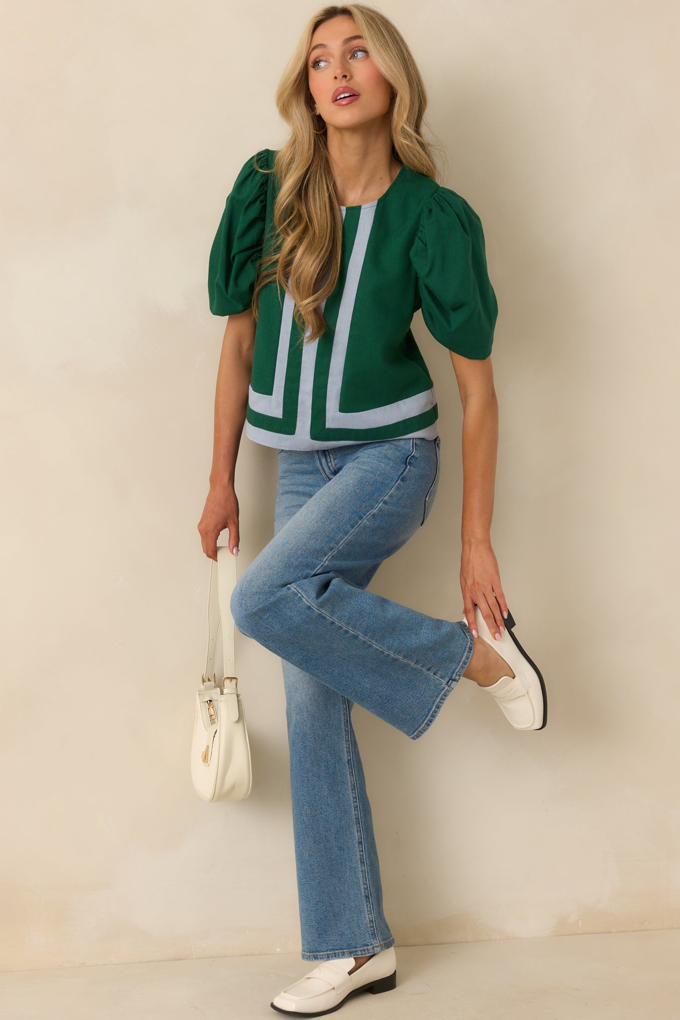 Green top with light blue contrast trim along center seam, crew neckline, short puff sleeves, and relaxed fit.