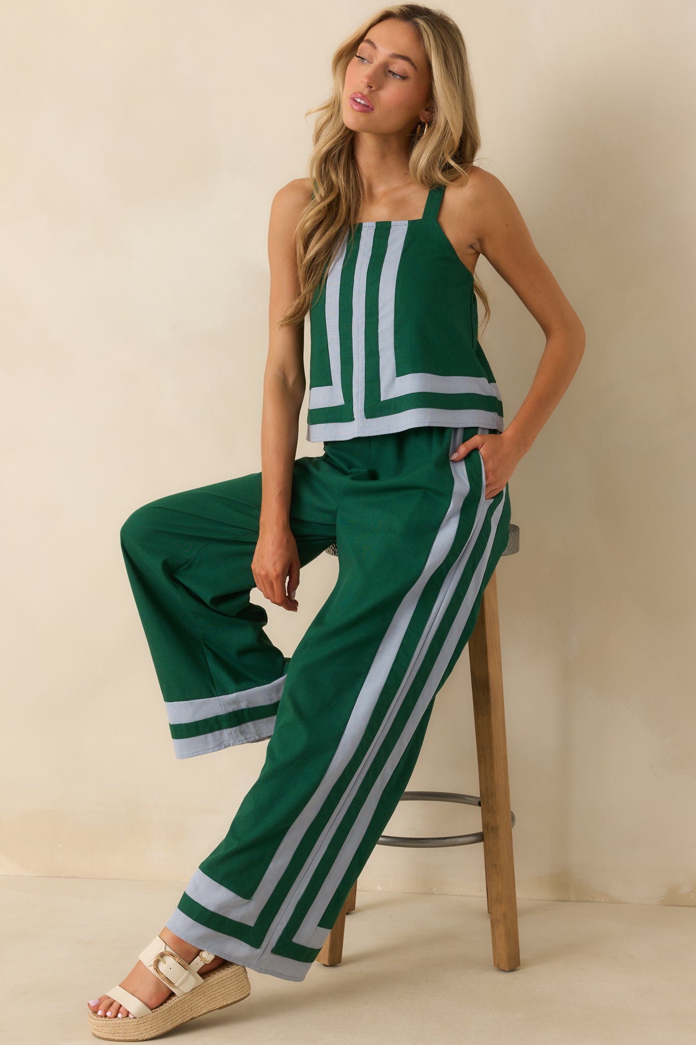 Green top with square neckline, adjustable straps, light blue contrast trim, elastic back insert, and relaxed fit.