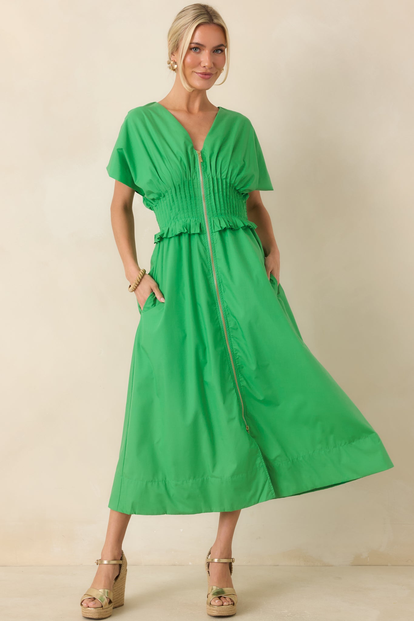 Green woven maxi dress showcasing a relaxed silhouette, soft shape, and functional side pockets.