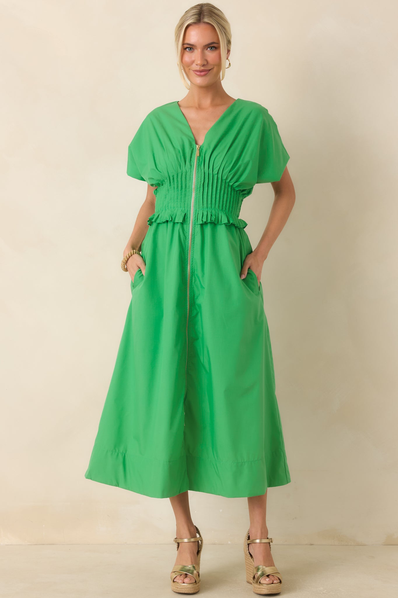 Green woven maxi dress featuring a V-neckline, front zip closure, short sleeves, and A-line skirt.
