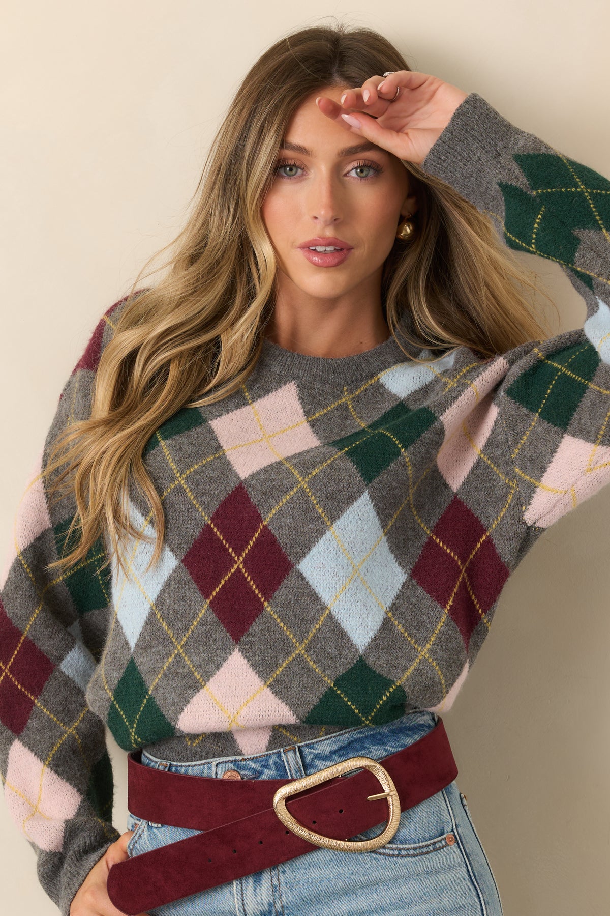 Argyle knit top with a grey base and multicolor diamond pattern framed by a classic crew neckline.