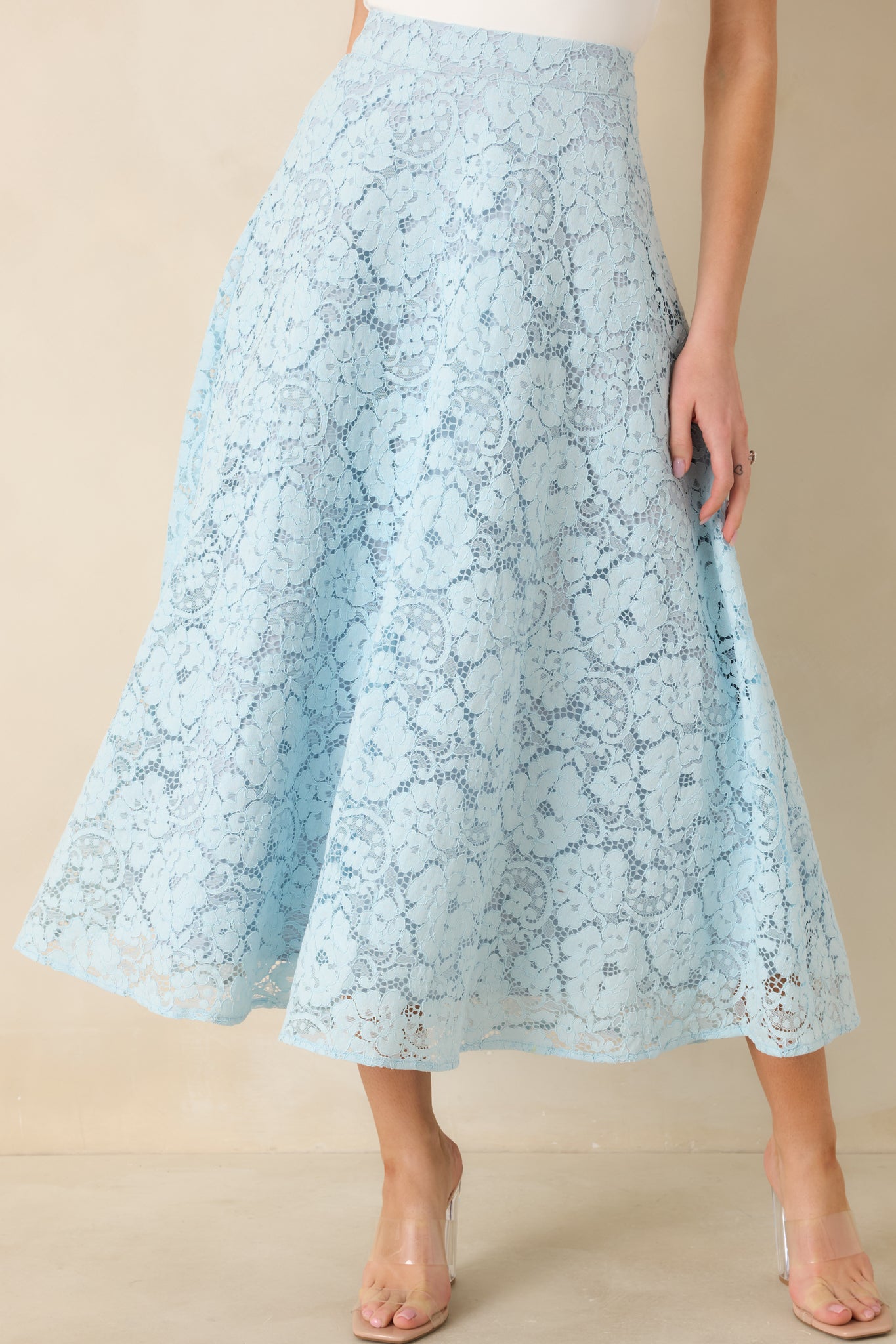 Guipure lace detail highlighting floral pattern and light blue underlayer.