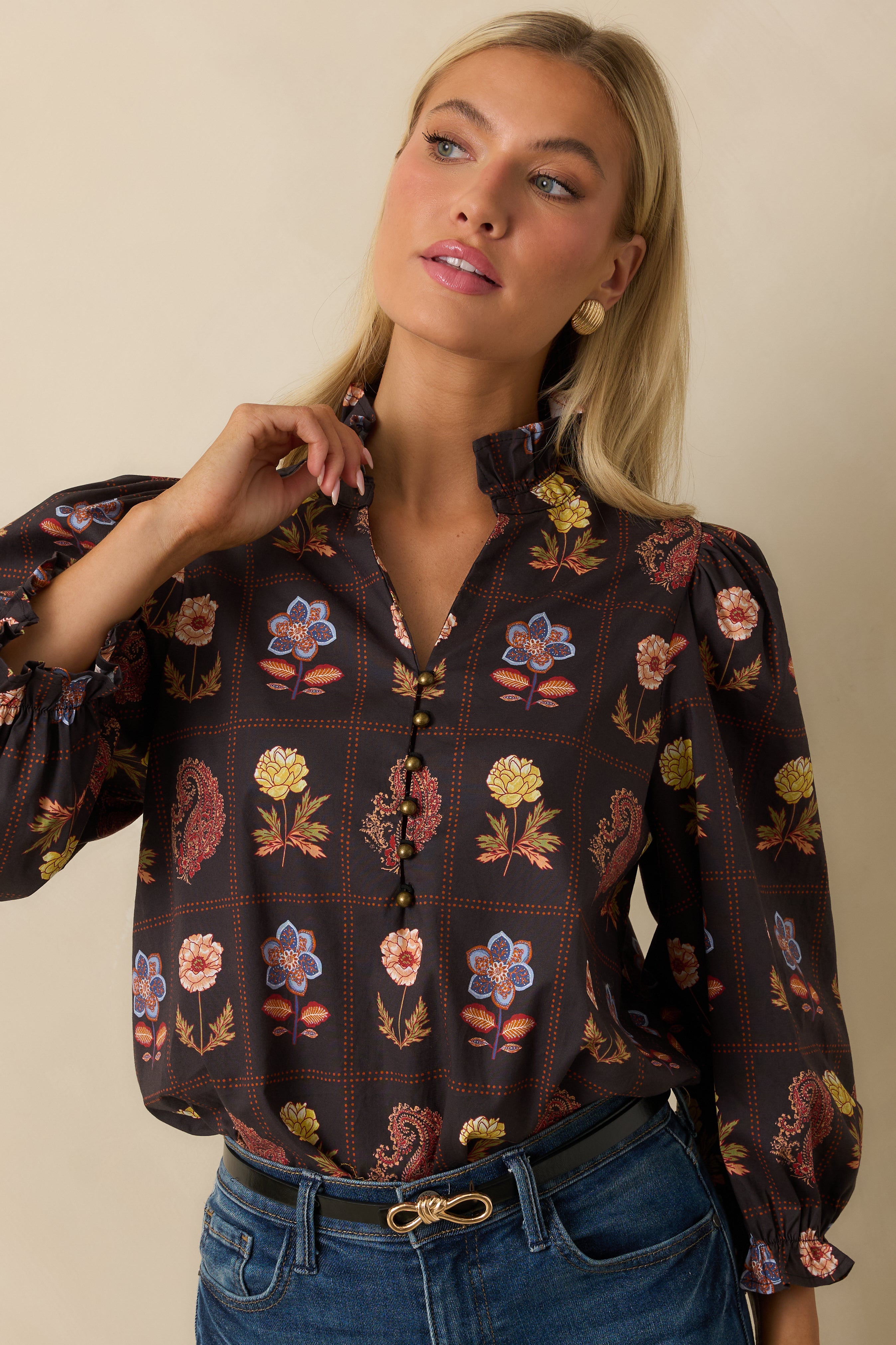 Detail of the half-button placket and floral pattern across the torso of the blouse.