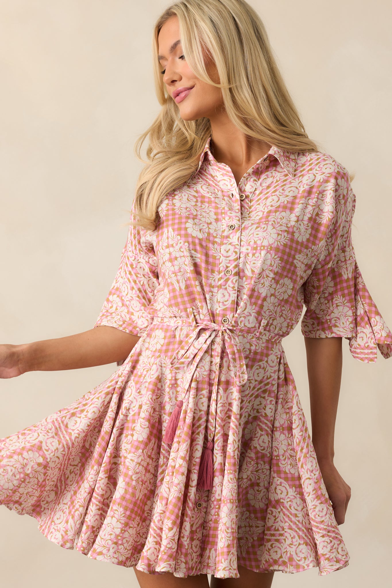 Half-length sleeves and lightweight fabric enhance the effortless charm of the gingham and floral design.