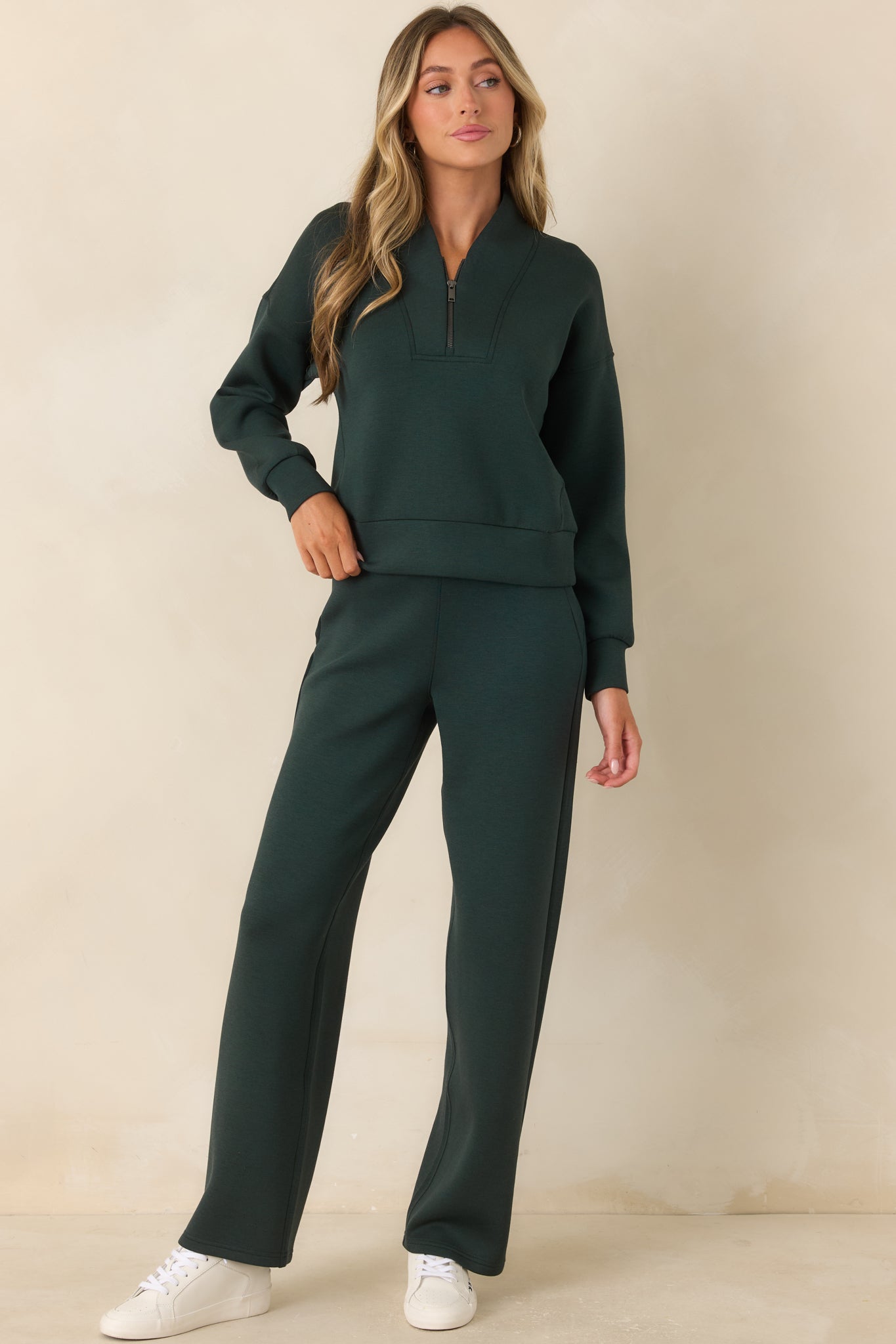 Half-zip pullover featuring a sculptural shawl collar, dropped shoulders, and a relaxed silhouette.