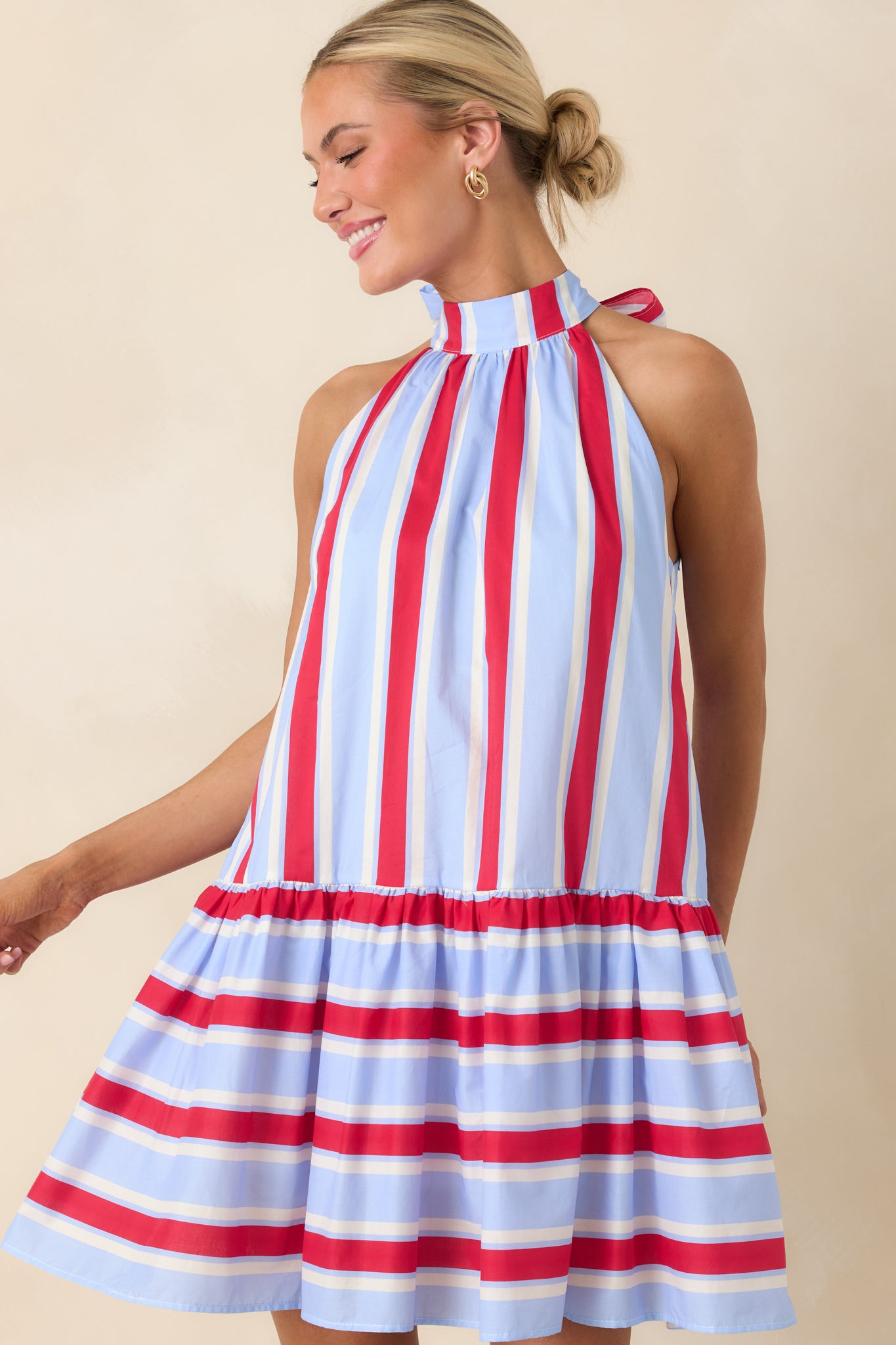 Halter neckline close-up with tie and subtle keyhole detail on striped fabric.