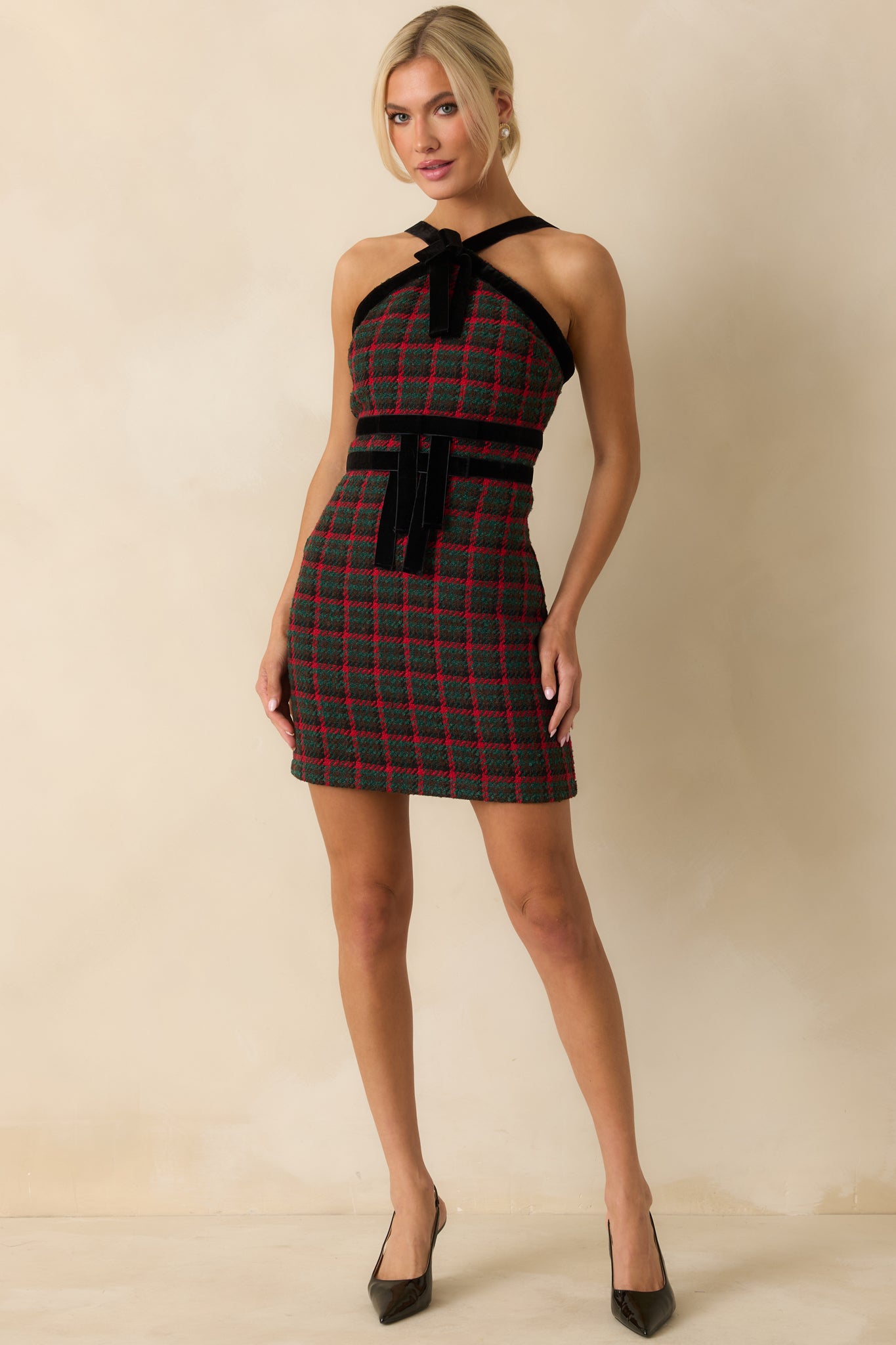 Halter-style plaid mini dress showcasing its structured bodice and velvet accents throughout.