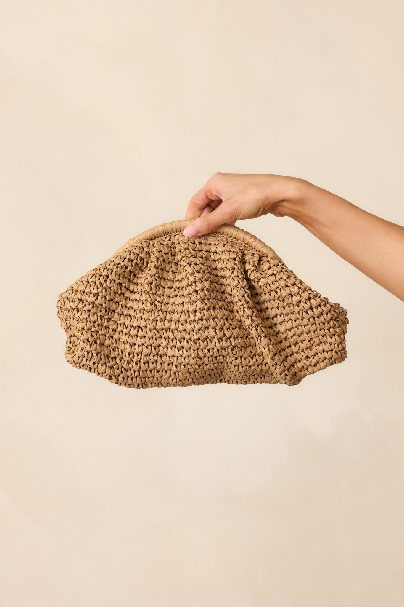 Closer look at the handbag’s top section, showing the hinge clasp closure and hints of the gold crossbody chain.