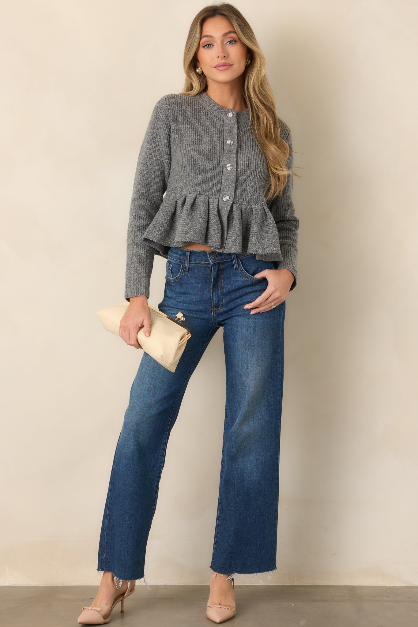 Heather gray knit cardigan with a polished fitted shape, long sleeves, round neckline, plaid-covered buttons, contrasting trim, and structured peplum hem.