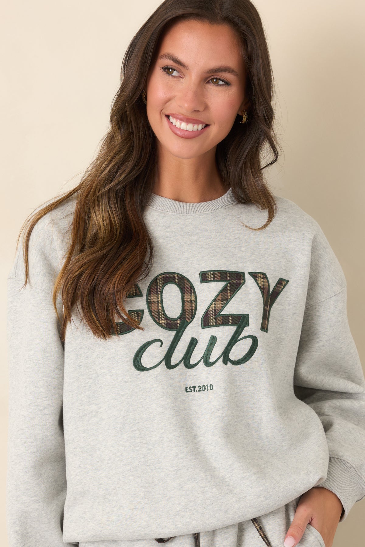 Plaid lettering stands out against the heather grey fabric of this relaxed crewneck sweatshirt.
