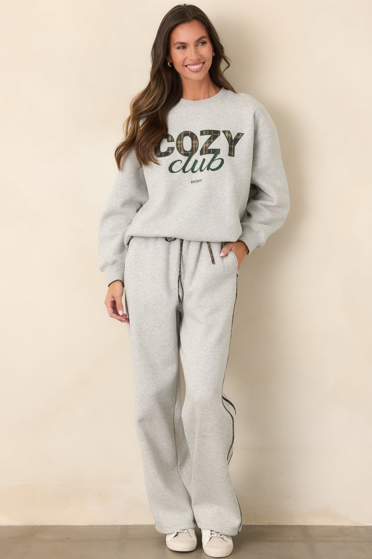Heather grey sweatpants with subtle plaid stripe detailing, an elastic waistband, and relaxed straight-leg fit.