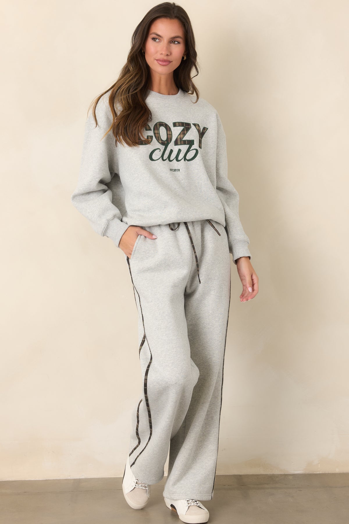 Casual heather grey sweatpants with a relaxed straight-leg silhouette and coordinating plaid stripe detail.