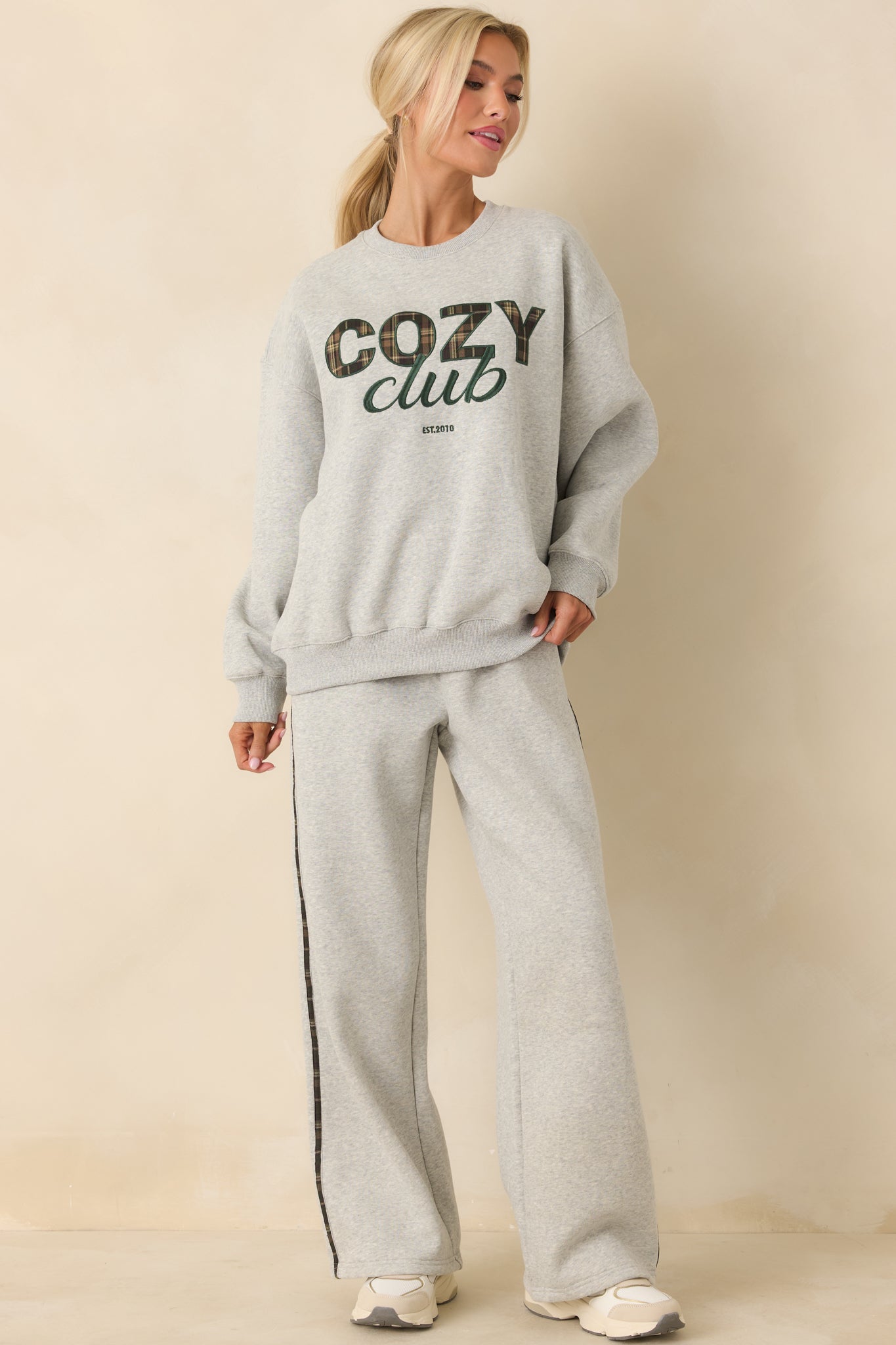 Heather grey sweatpants with relaxed straight-leg fit and contrast plaid side detailing.