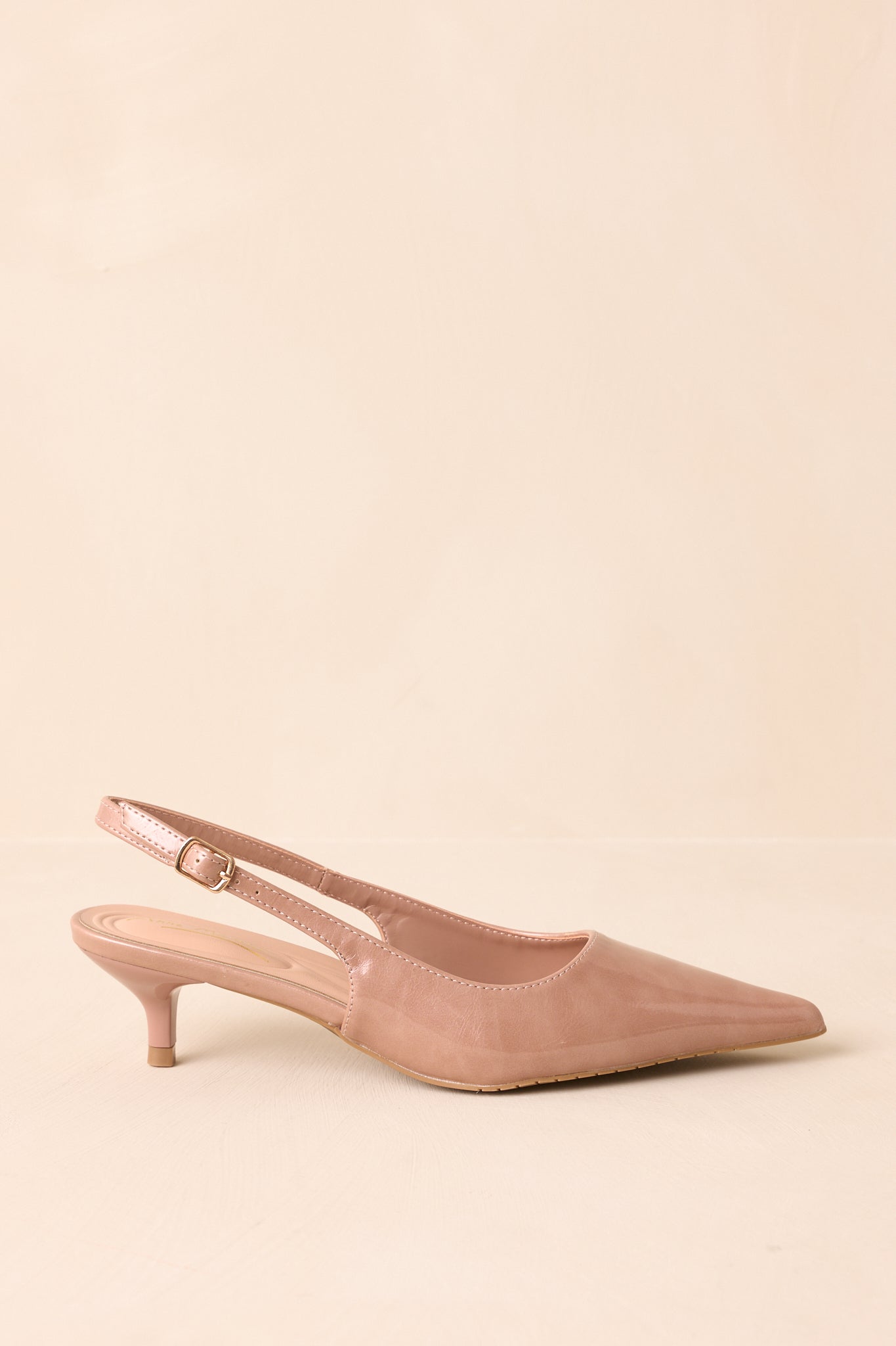 Side profile of the heels highlighting the sleek patent finish and kitten heel height.