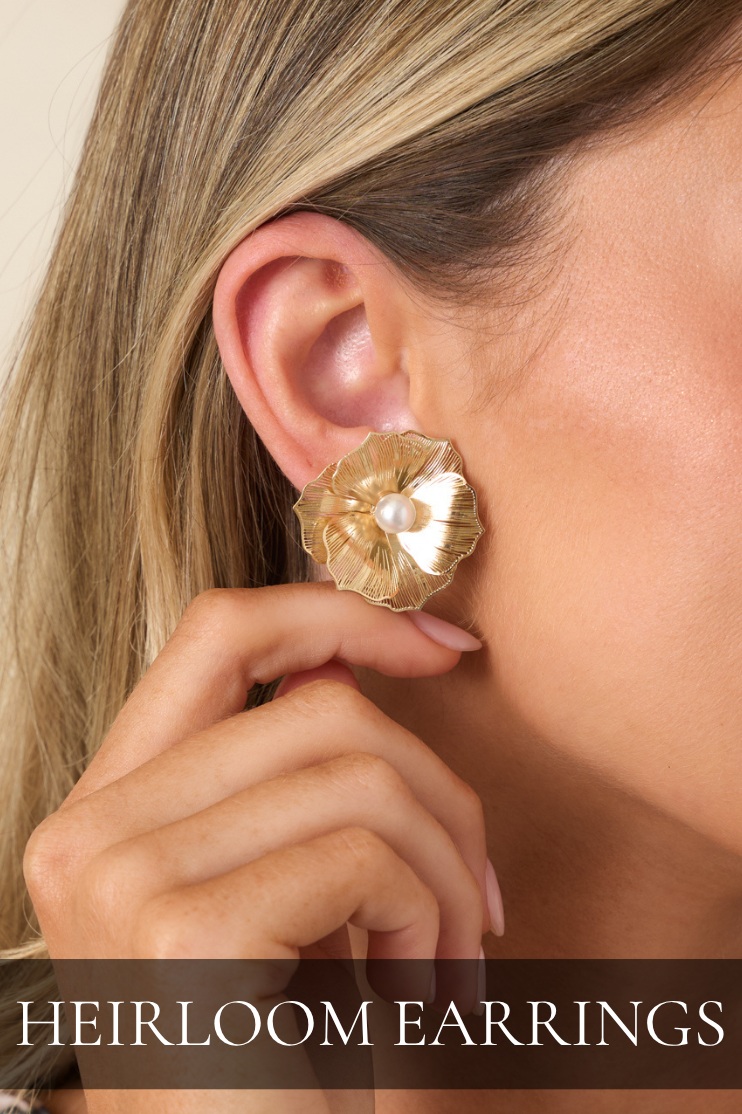 Model wearing gold pearl earrings. Text reads: "Heirloom Earrings."