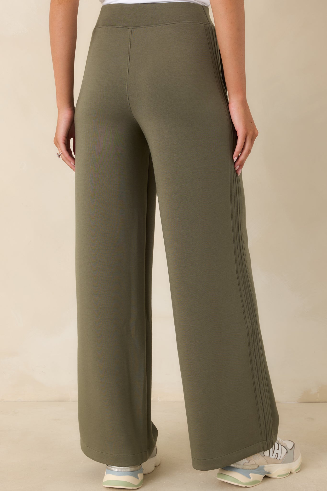 Rear view of the herb green wide-leg pants featuring a high-rise waistband, fluid silhouette, and clean back design.