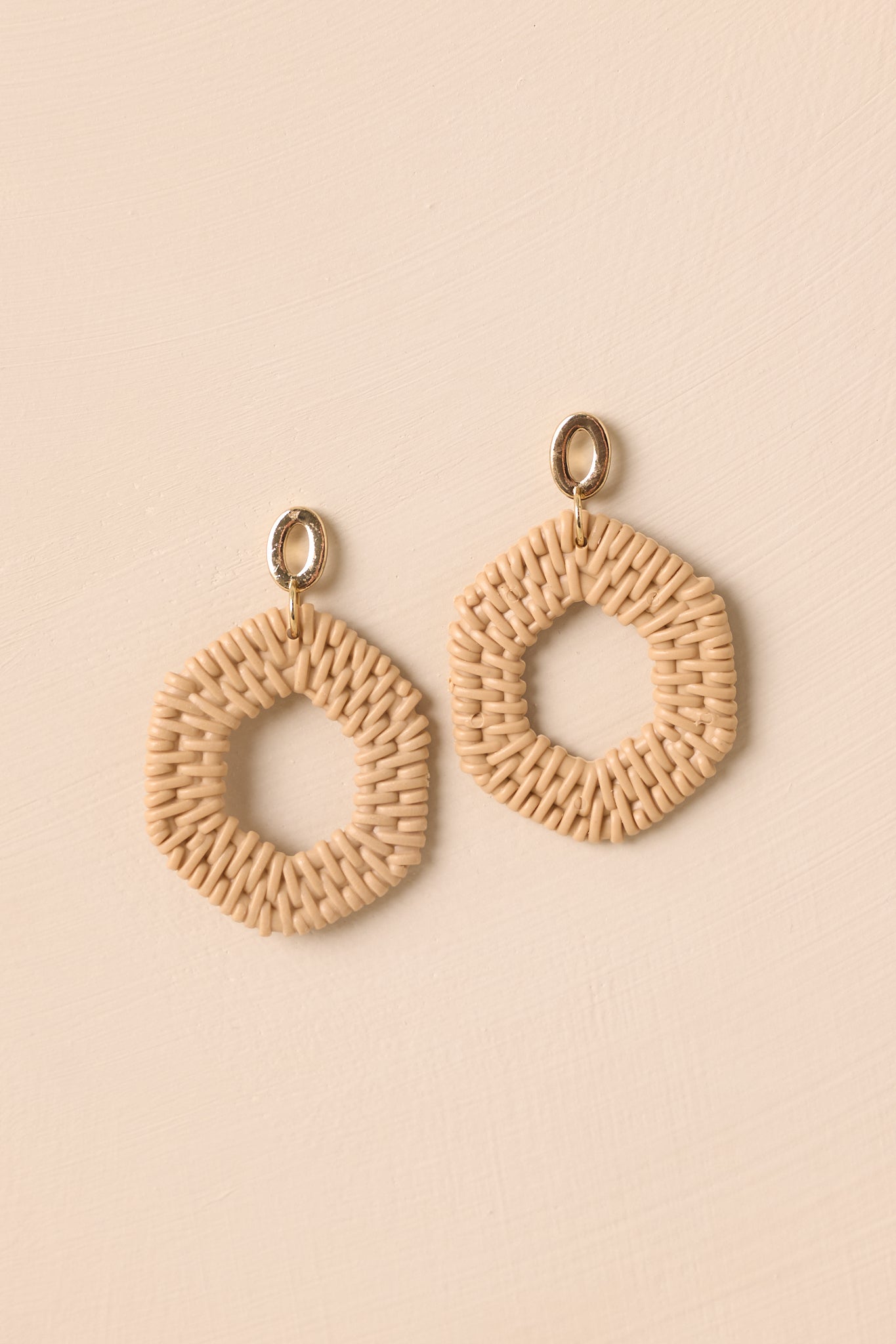 Textured hexagon drop earrings with golden oval tops styled on a neutral background.
