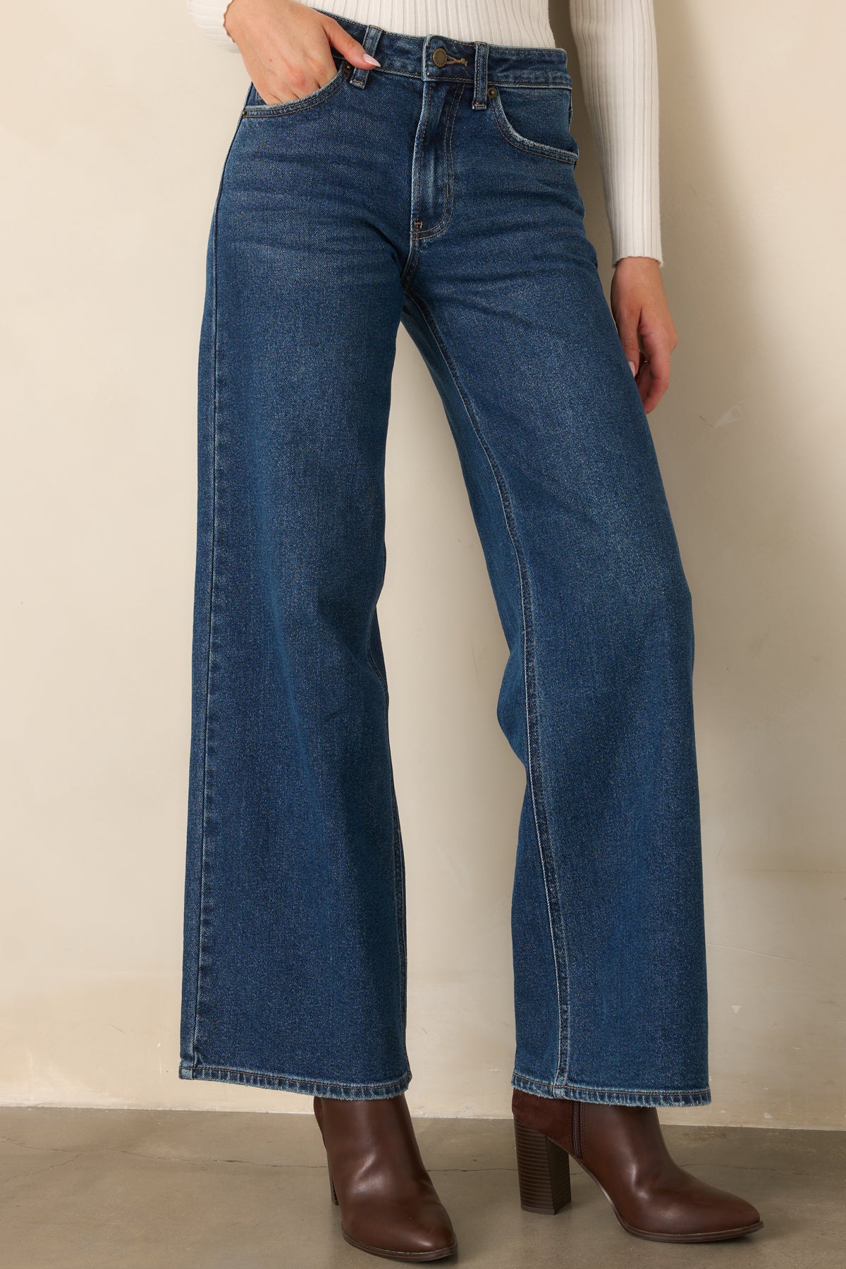 Classic front pockets and a zip fly complete the clean design of these high-rise blue denim jeans.