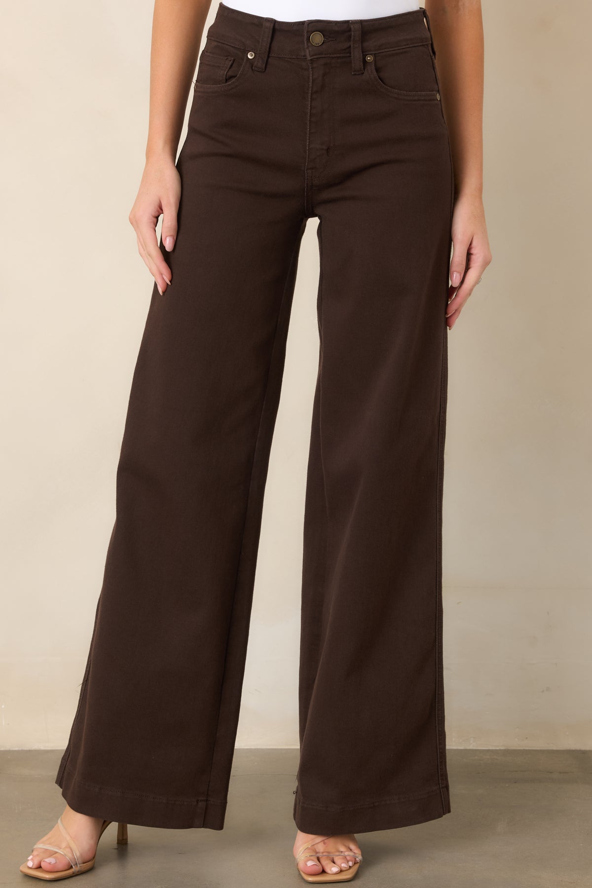 High-rise brown denim featuring a relaxed wide-leg shape and timeless pocket construction in a versatile deep wash.