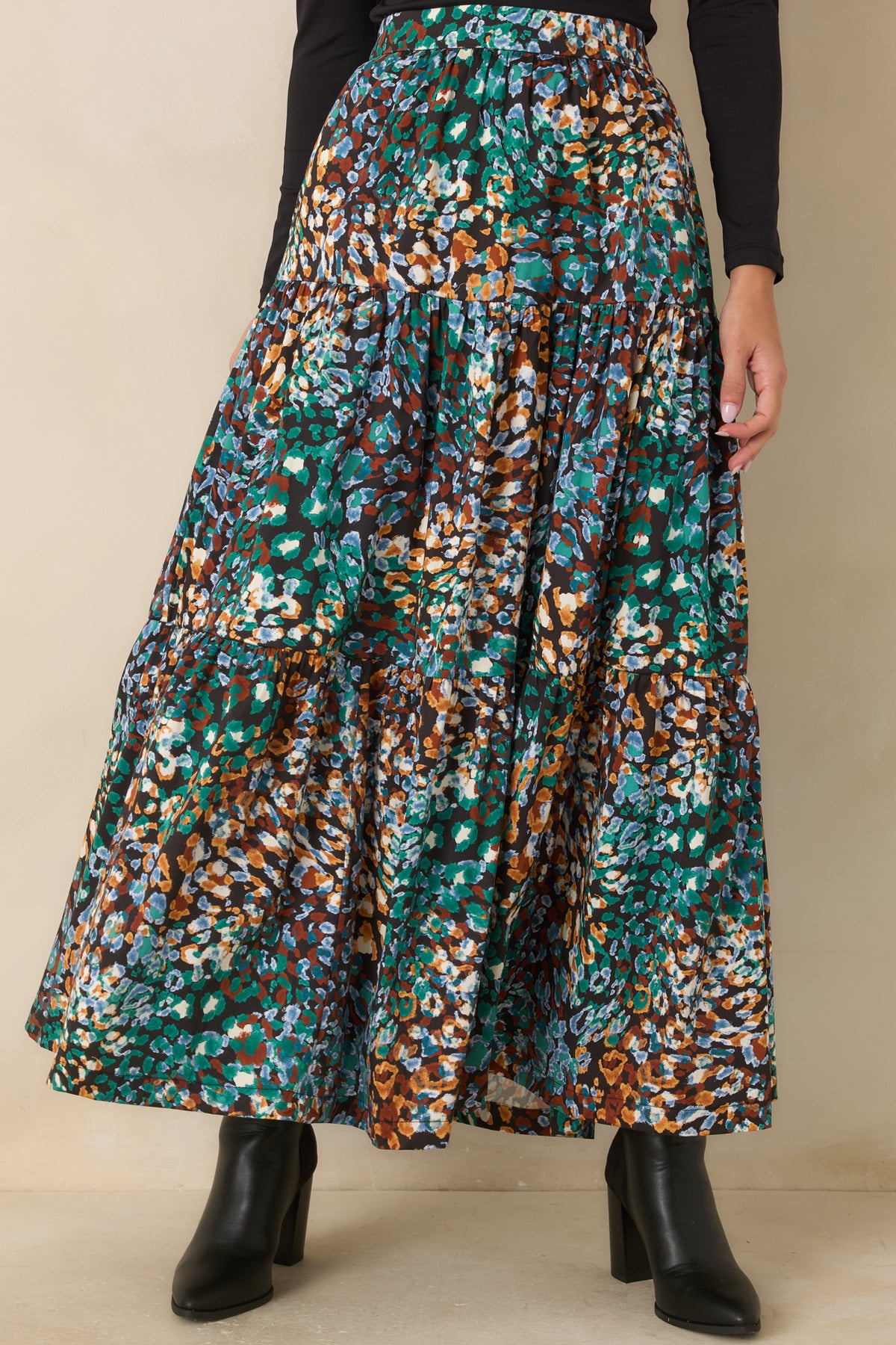 High-rise skirt featuring the colorful abstract print and softly flowing tiered construction.