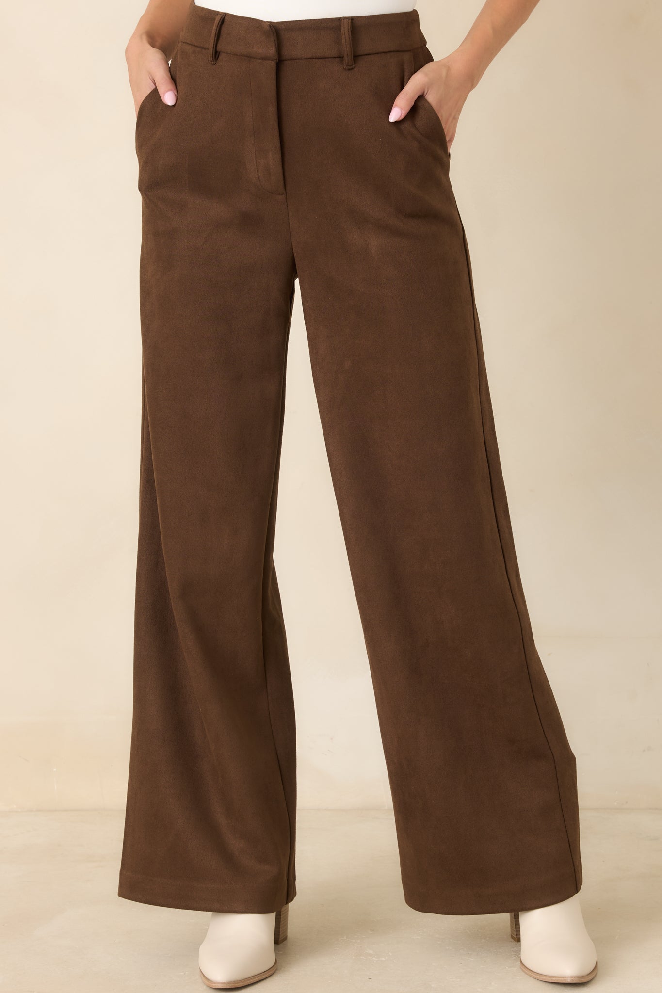 Close view of the high-rise waistband highlighting the belt loops, concealed front closure, and structured front construction.