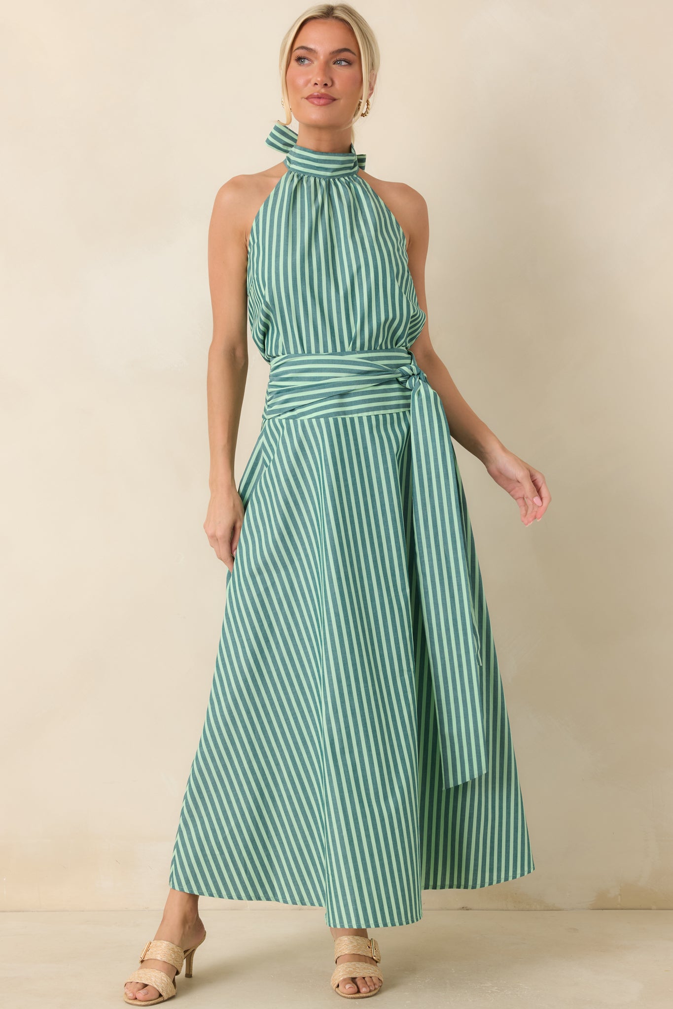 Lightweight cotton maxi skirt featuring a high-rise waistband, oversized self-tie sash, and softly striped full-length silhouette with flowing movement.