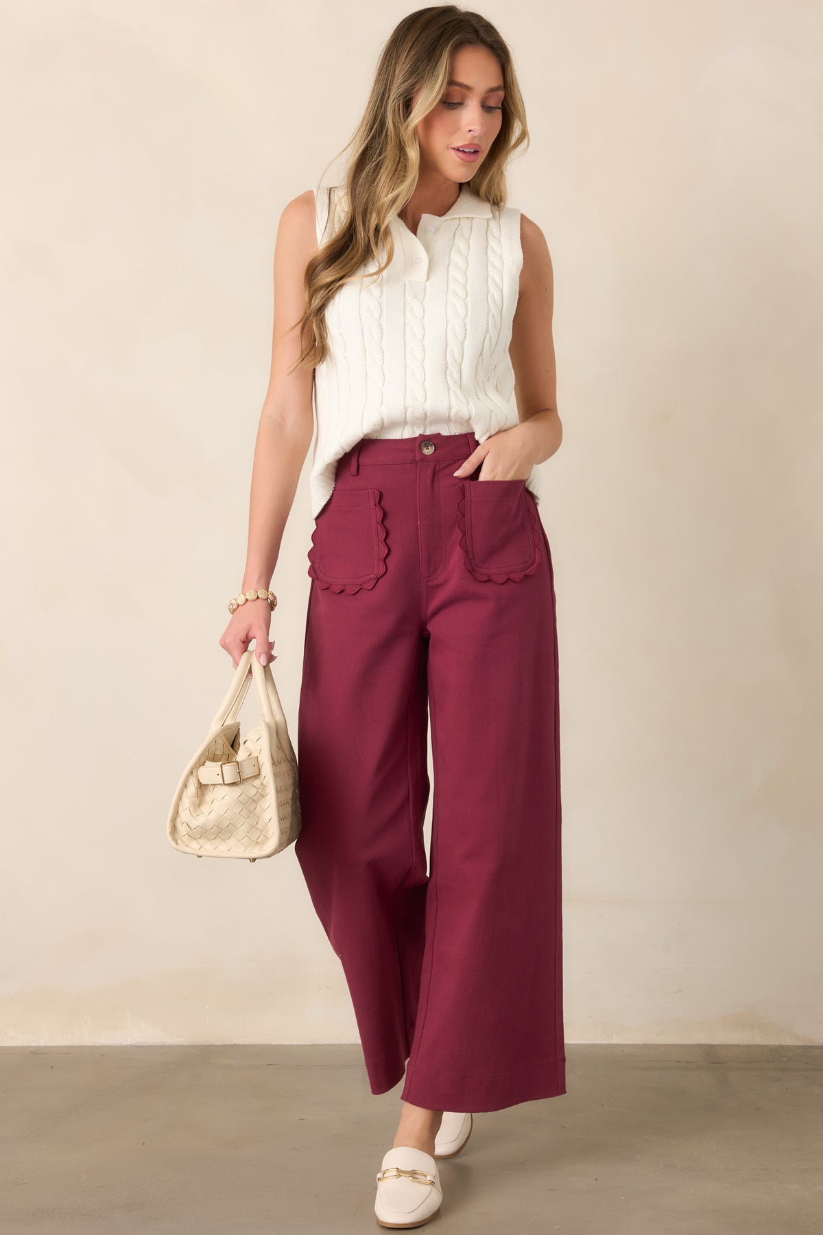 Wide-leg cotton pants featuring a flattering high-rise waist, feminine scalloped patch pockets, belt loops, and a polished structured silhouette.