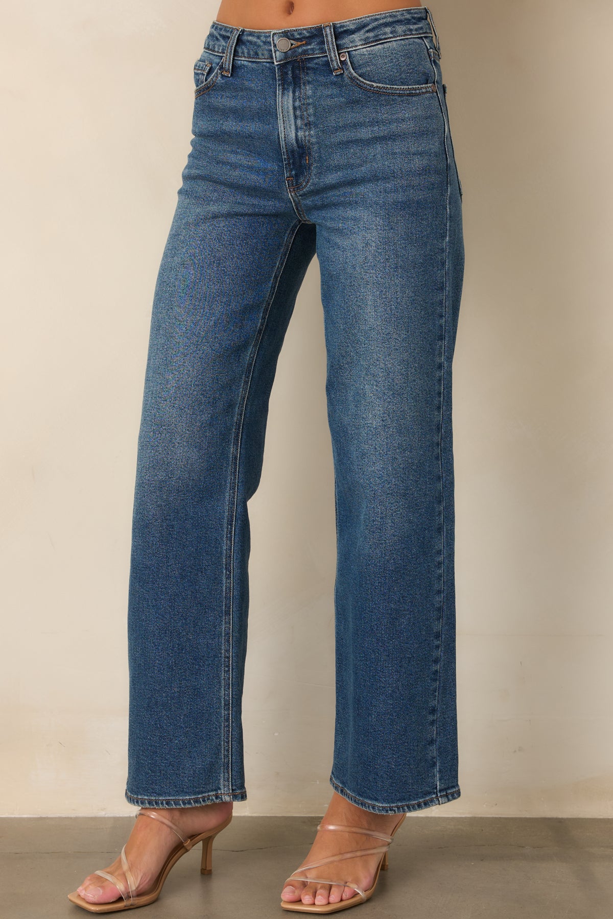 High-rise denim showcasing the button closure, zip fly, and classic pockets.

