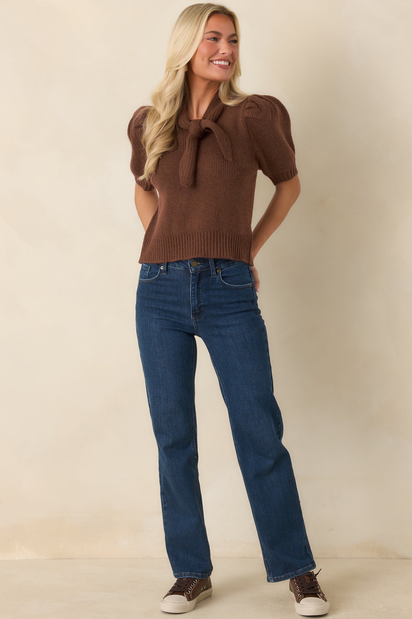 High-rise denim jeans designed with a timeless straight-leg fit, zip fly closure, and lightly faded finish.