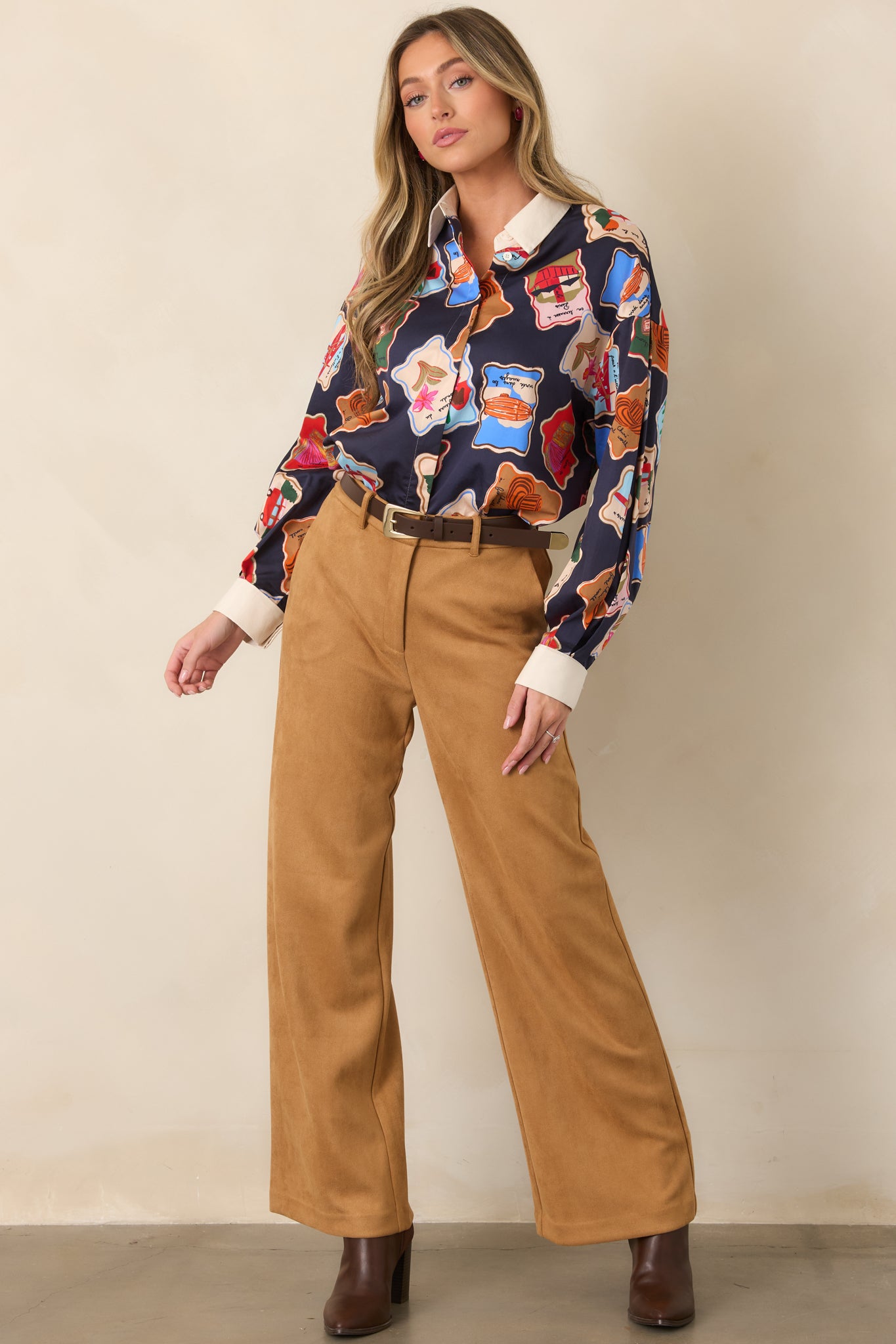 Wide-leg pants featuring a structured high-rise front, elasticized back waistband, belt loops, concealed front closure, and full-length polished silhouette.