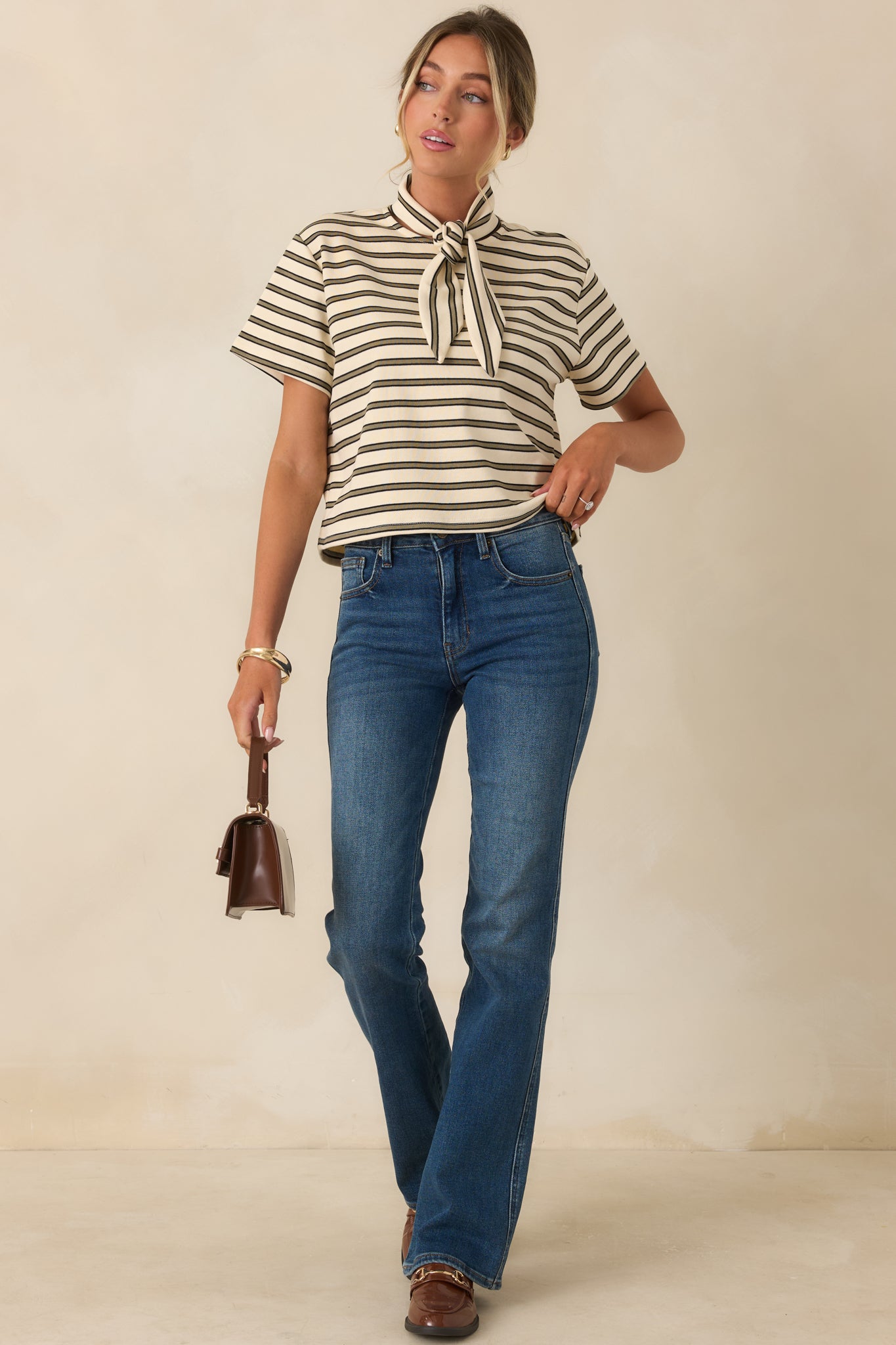 High rise jeans in a deep indigo wash featuring a close-fitting silhouette through the hips and thighs and a gently flared bootcut leg.