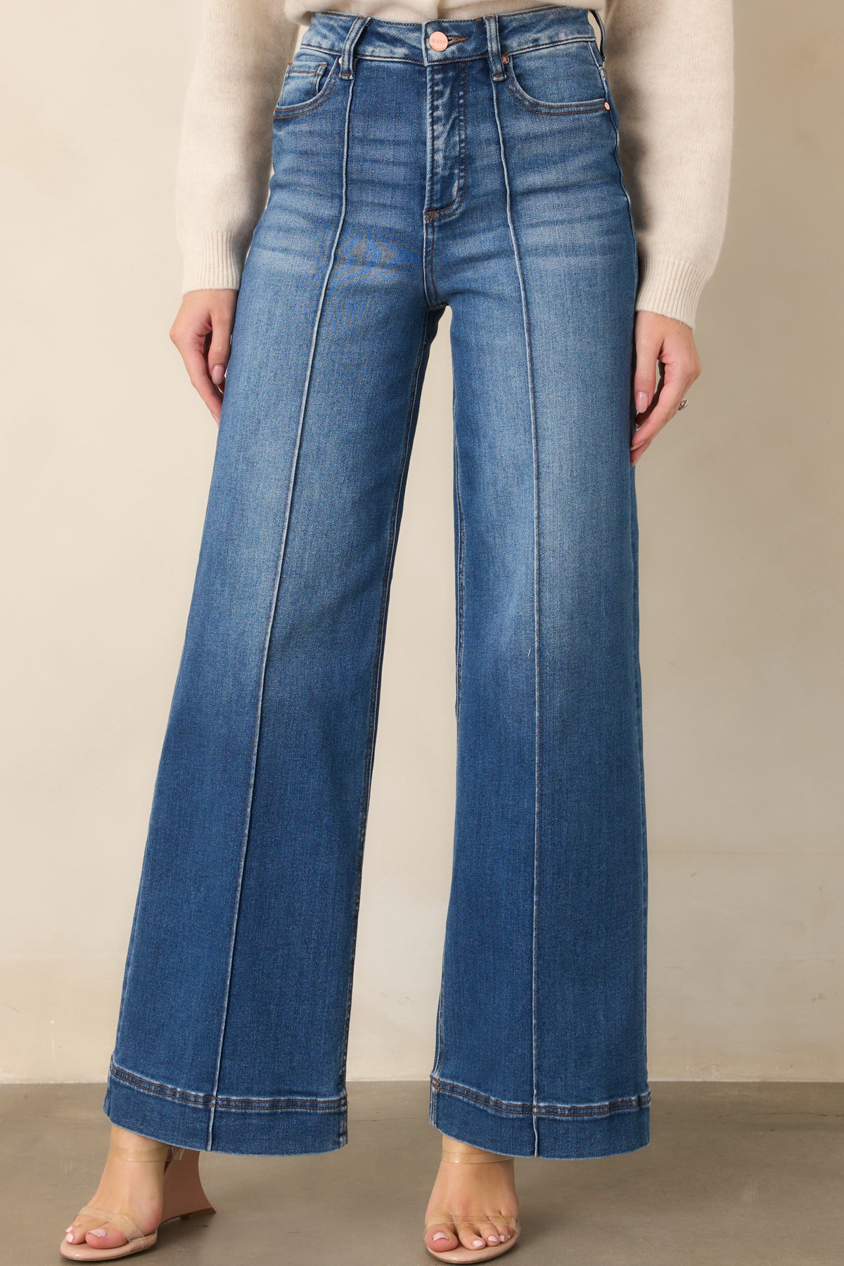 High-rise jeans showcasing the classic button and zipper closure.