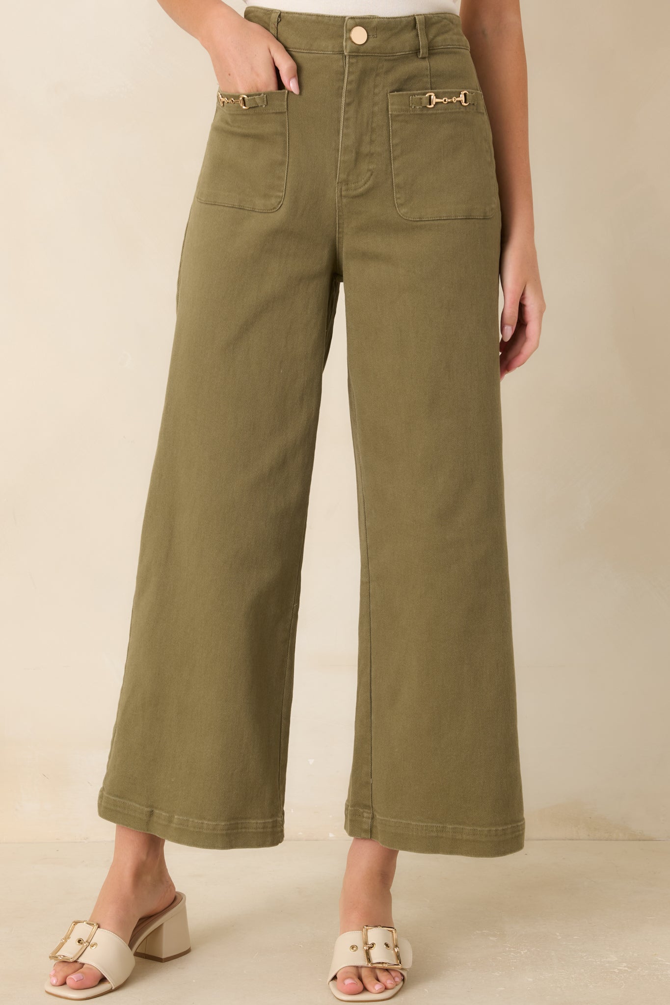 The front of these high-rise jeans highlights the oversized patch pockets and gold-tone horsebit hardware.