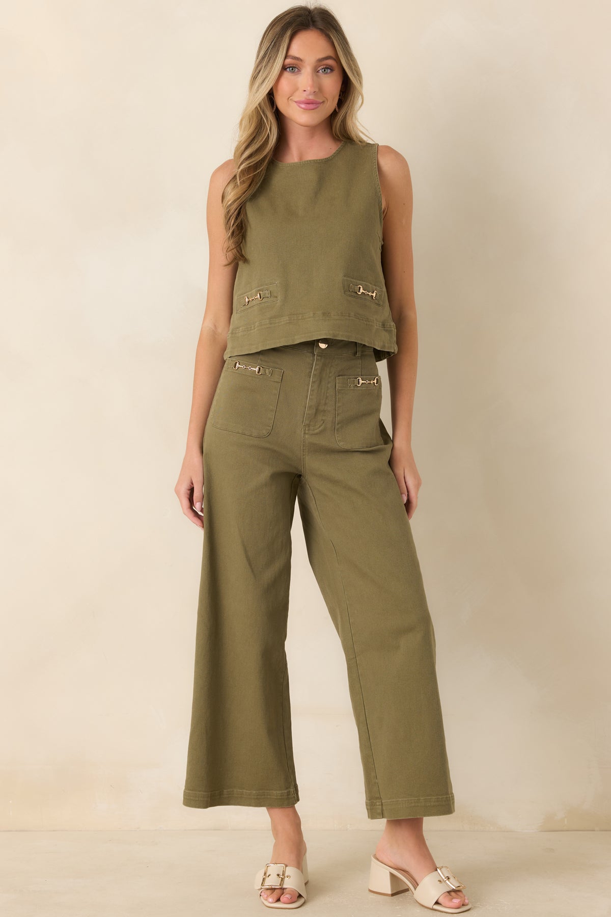 High-rise wide leg jeans featuring oversized front patch pockets, ankle-length hems, and polished gold-tone horsebit accents.
