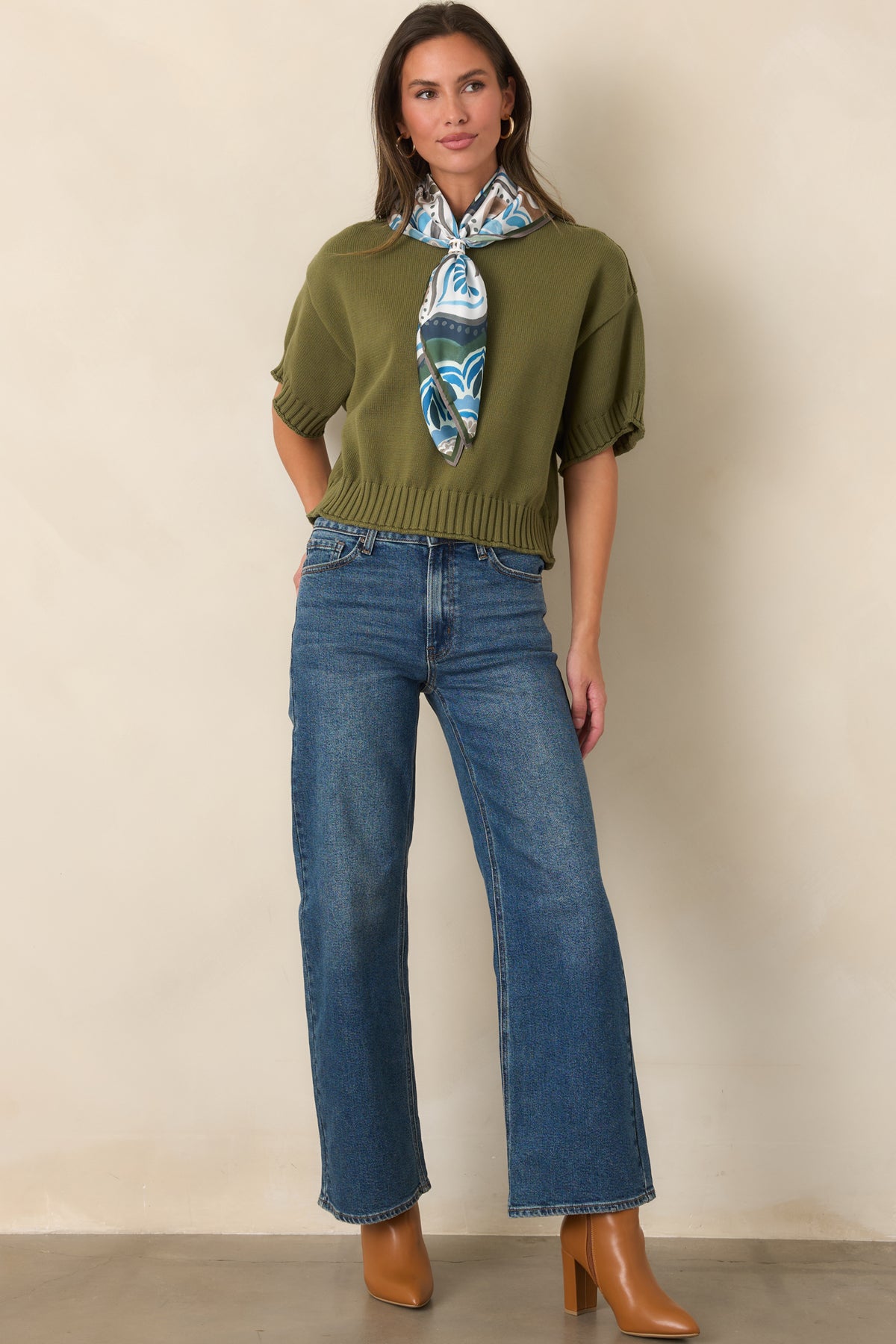 High-rise medium wash jeans featuring a classic five-pocket design and straight legs.
