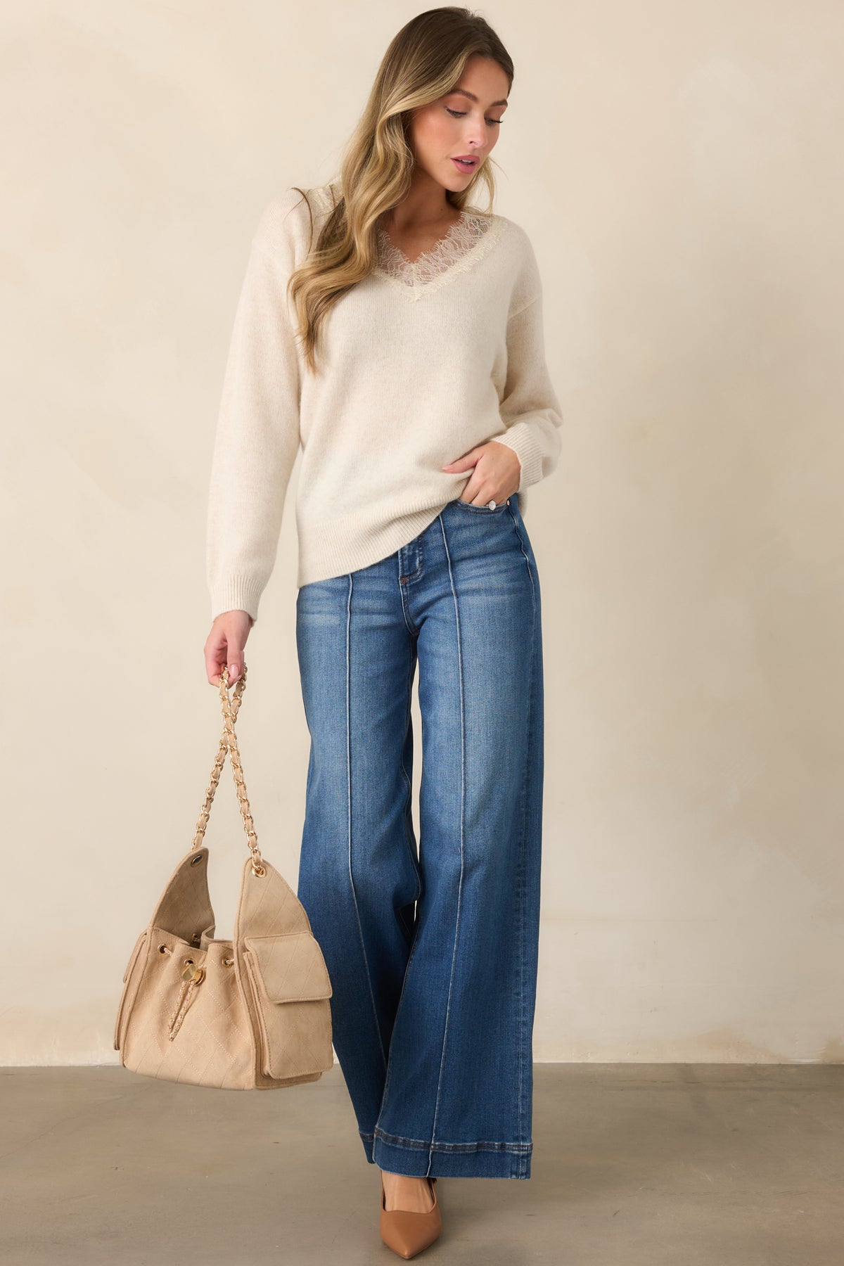High-rise medium wash jeans with a polished trouser-inspired finish.